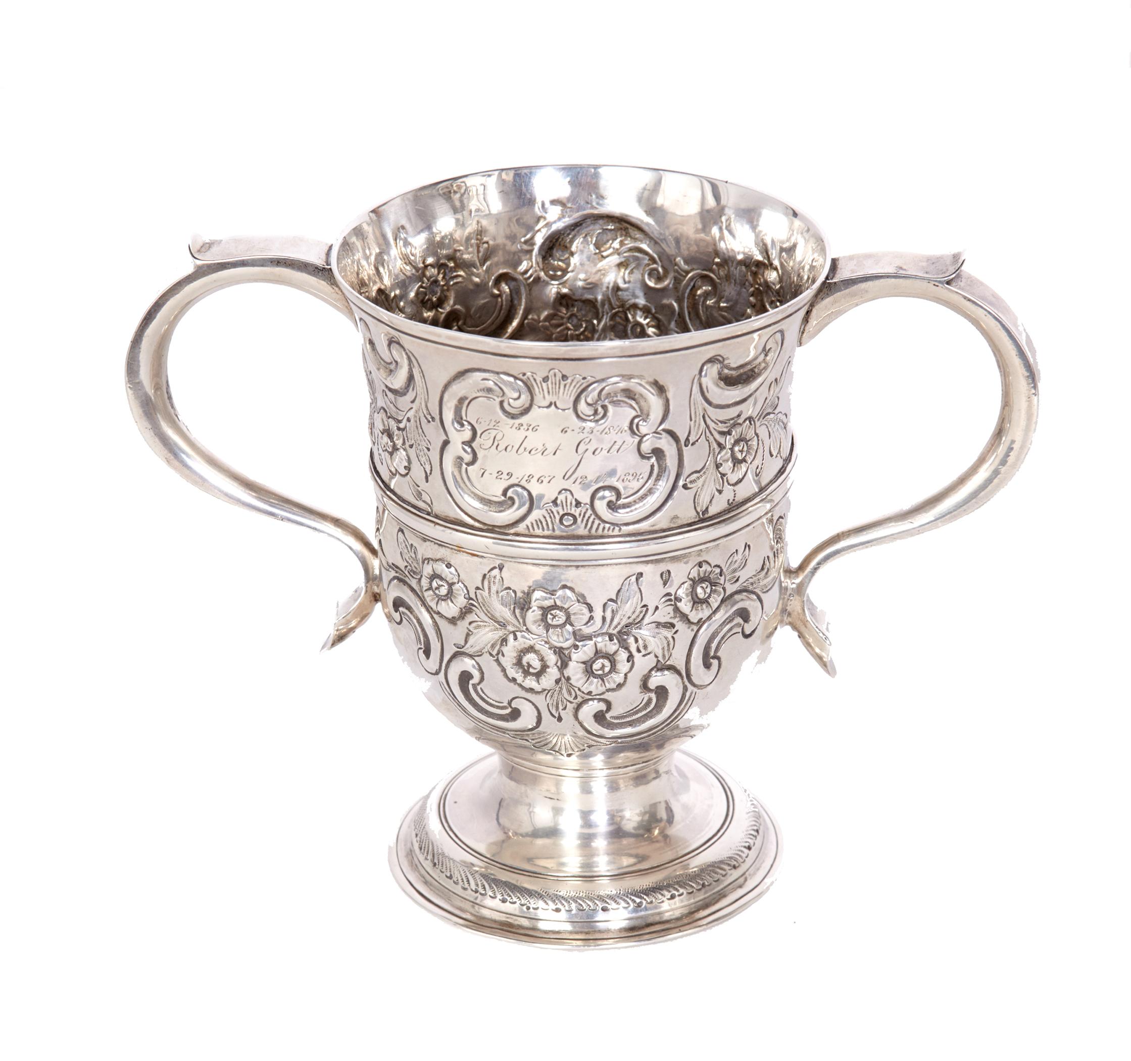 Sterling silver 2-handled loving cup made in London in 1762 by Thomas Whipham and Charles Wright. Fully hallmarked on the bottom this cup is in excellent condition. Beautifully decorated with flowers and scrolls it is 5 1/8