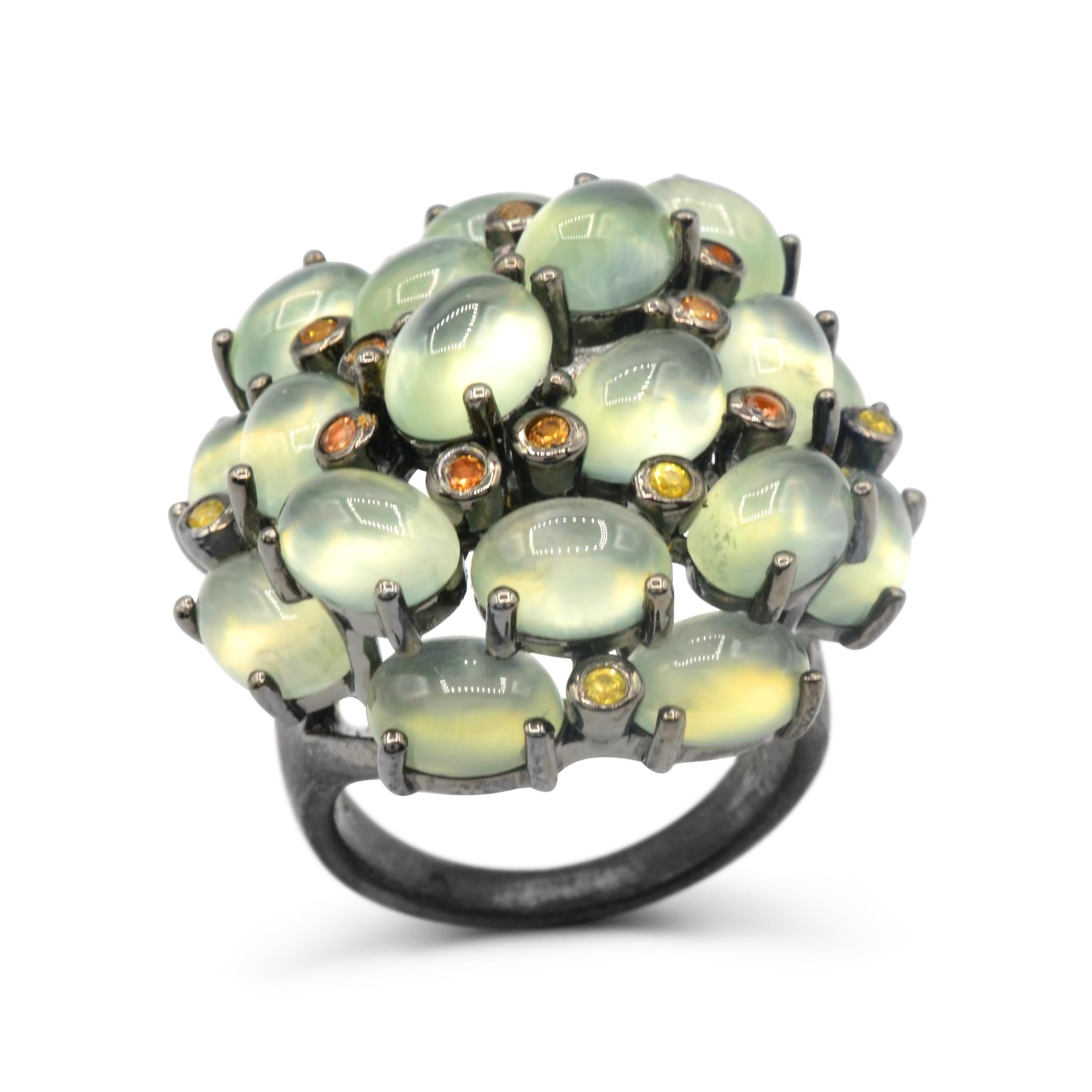 Natural Prehnite is said to enhance calmness and bring you inner peace.  This bold fashionable ring is made with 925 Sterling silver plated with black rhodium to make an elegant contrast with the Clustered Moss Green Cabochon Shaped Prehnite with