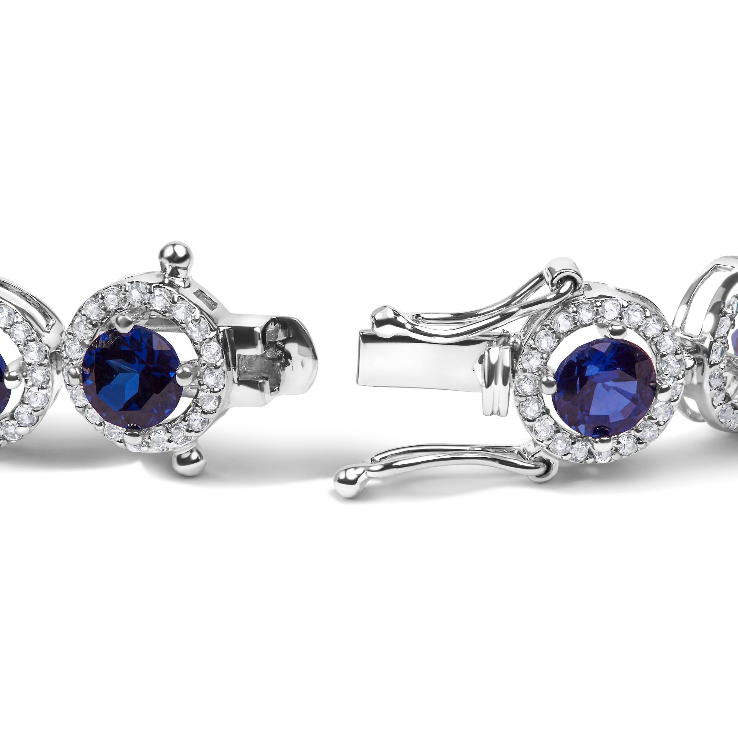 Indulge in the celestial allure of this captivating .925 Sterling Silver Link Bracelet. Adorned with a mesmerizing 21.0 Cttw of lab-created Blue Sapphire and White Topaz gemstones, this bracelet exudes a celestial charm. The elegant round-shaped
