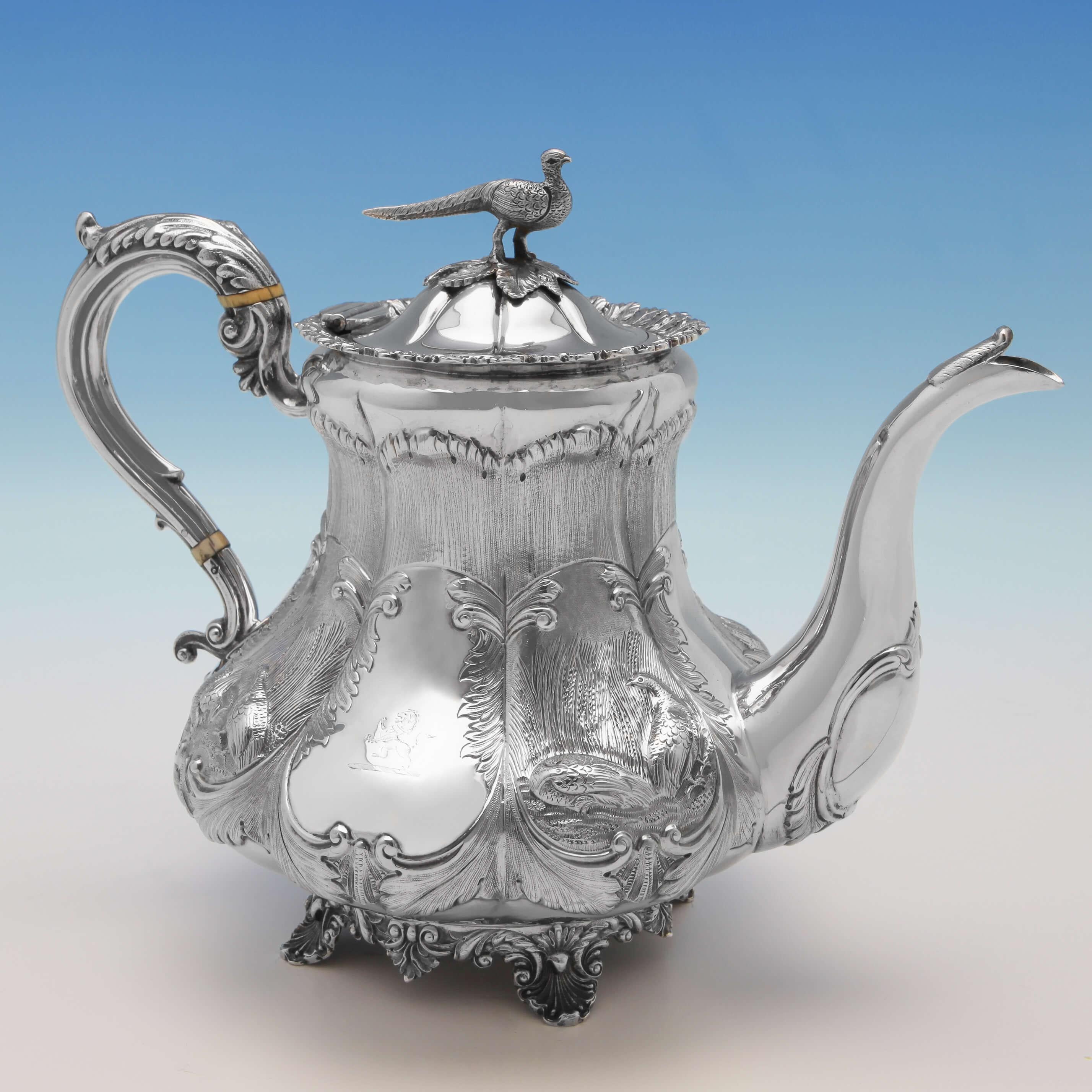 Hallmarked in London in 1836 by Benjamin Stephens, this impressive, William IV Antique, sterling silver 3 piece tea set, has a melon shaped body chased with scenes depicting pheasants in woodland, and acanthus and scroll work. The set features