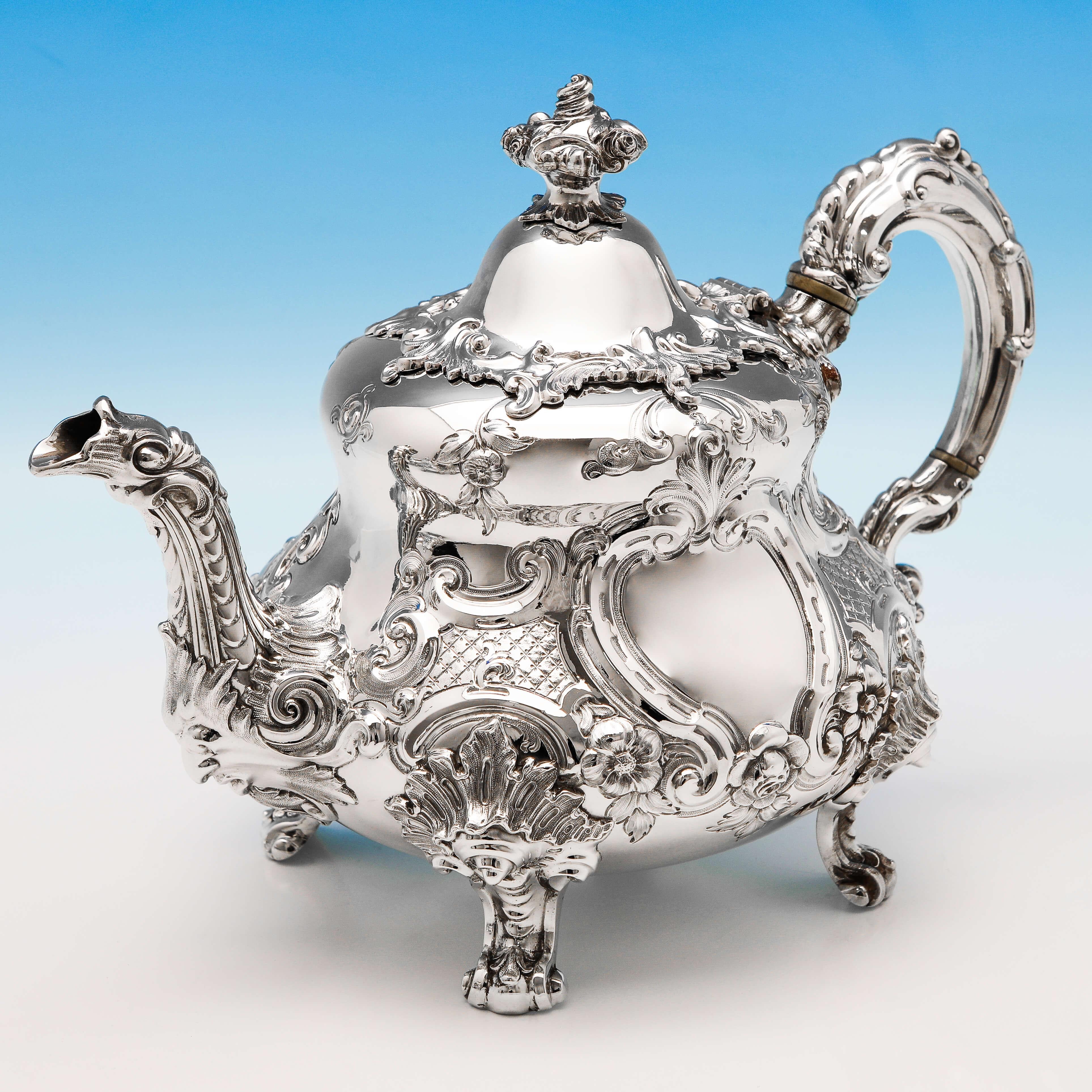 Hallmarked in London in 1855 by Barnards, this striking, Victorian, antique sterling silver tea set, is ornately chased throughout, and features silver handles and gilt interiors to the sugar and cream. The teapot measures 8.5