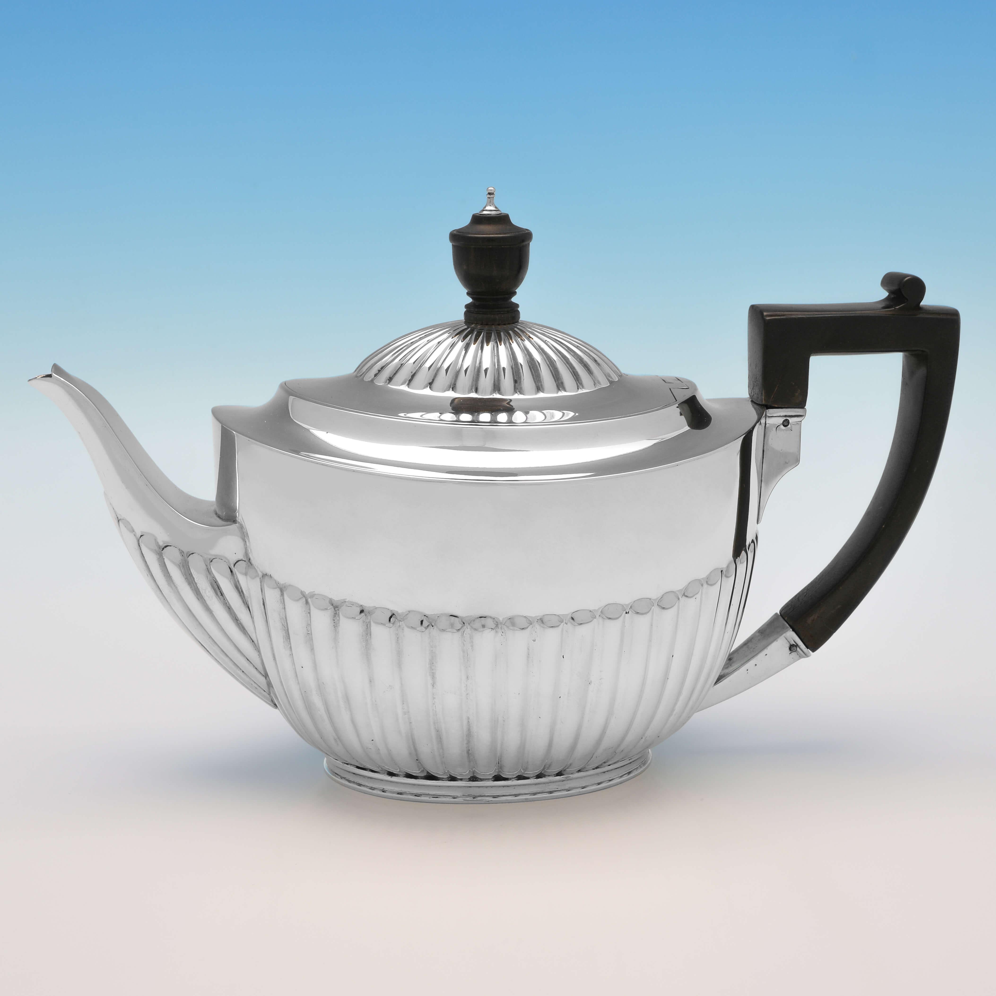 Hallmarked in London in 1883/1884 by Barnards, this stylish, Antique Sterling Silver 4 Piece Tea Set, is in the classic 'Queen Anne' style, featuring half fluting to the bodies of each piece. The teapot measures 6