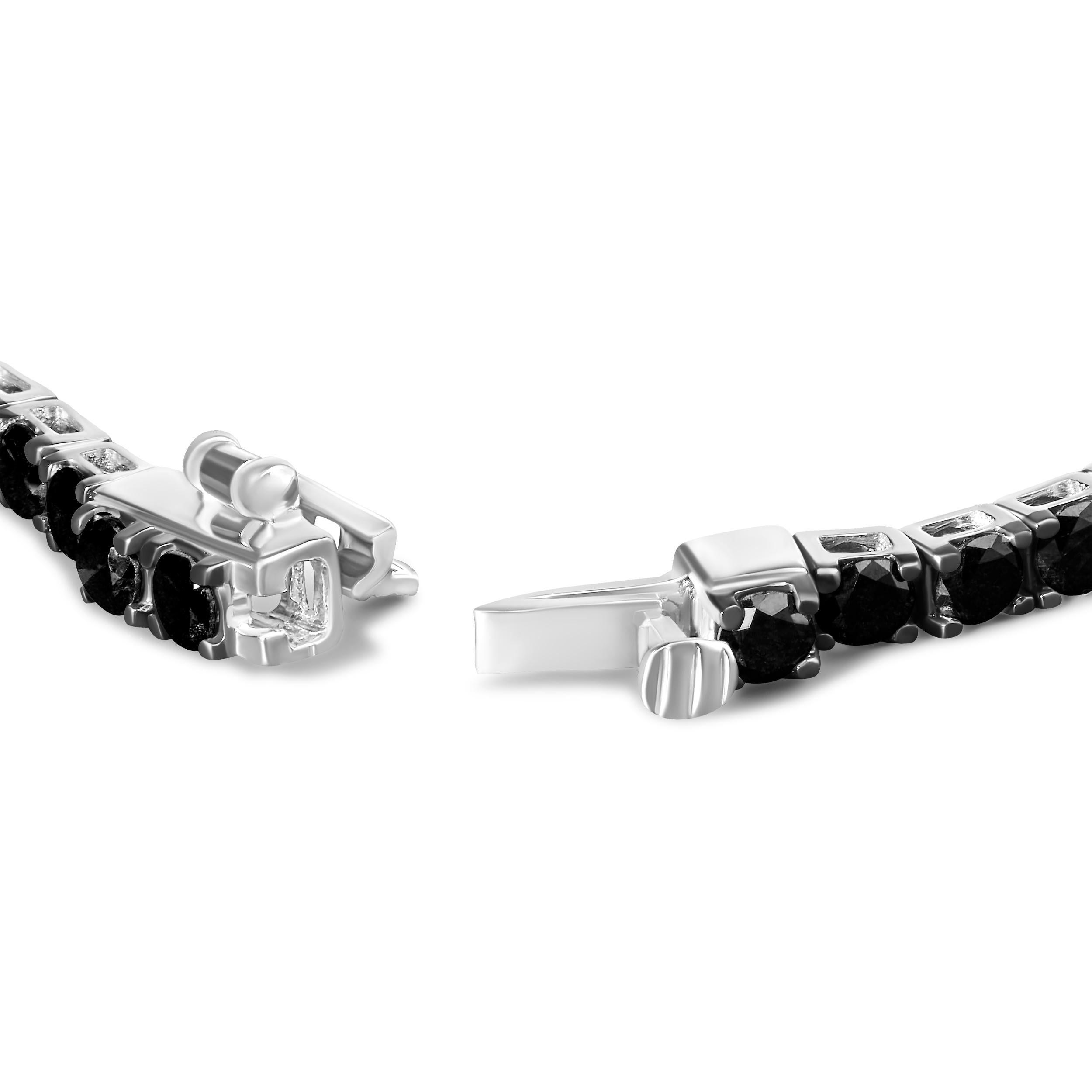 Elegant and timeless, this gorgeous .925 sterling tennis bracelet features 5.0 carat total weight of natural round brilliant cut treated black diamonds with a whopping 56 individual stones in all. The tennis bracelet has hinged links consisting of a