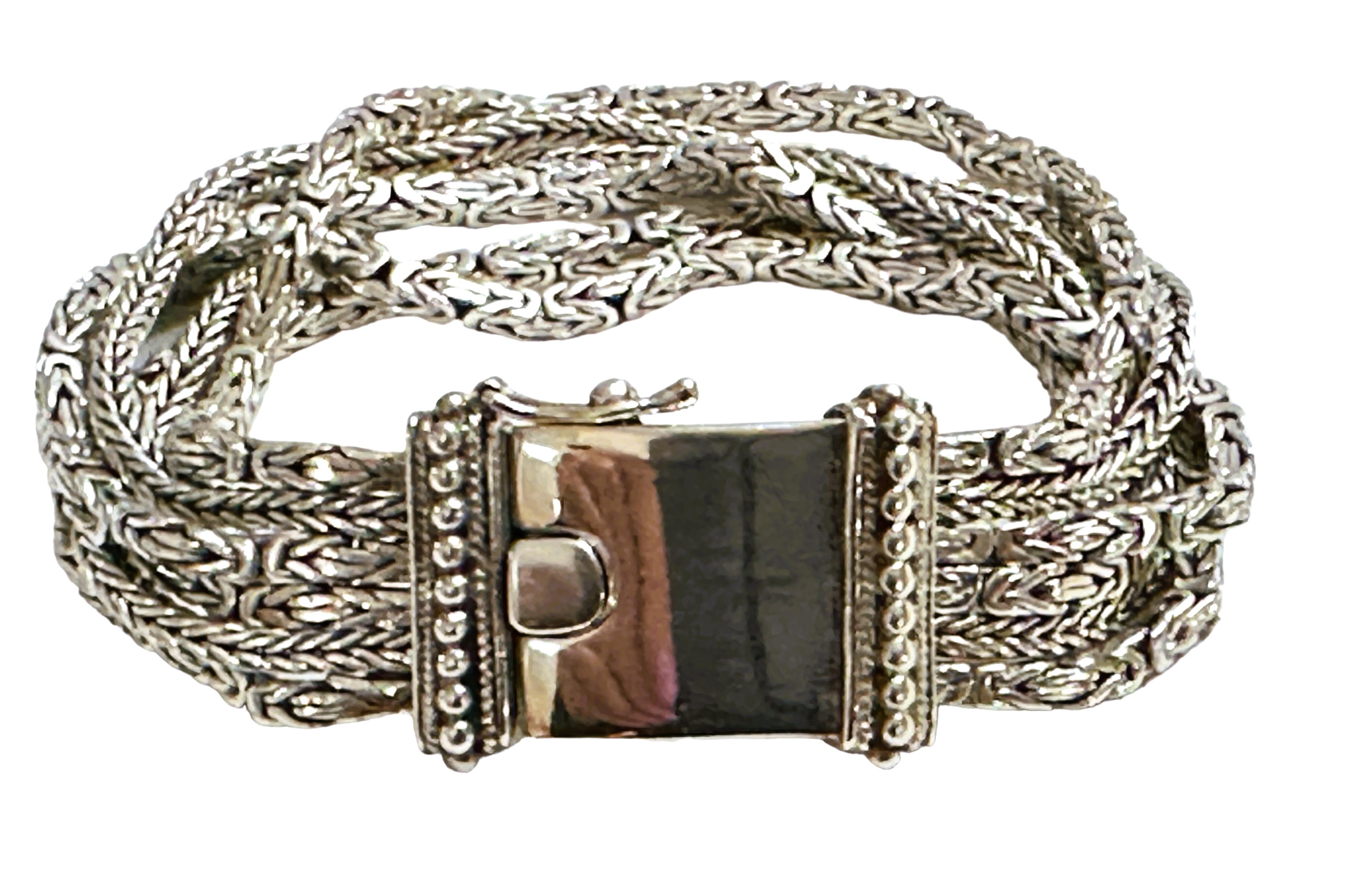 This is a pre-owned Sterling Silver Bracelet and it is in excellent condition..  The bracelet is 7.25 inches long and  .75 inches wide.  It has a nice sturdy box closure and a safety latch. This bracelet will surely get noticed.  It's truly the work