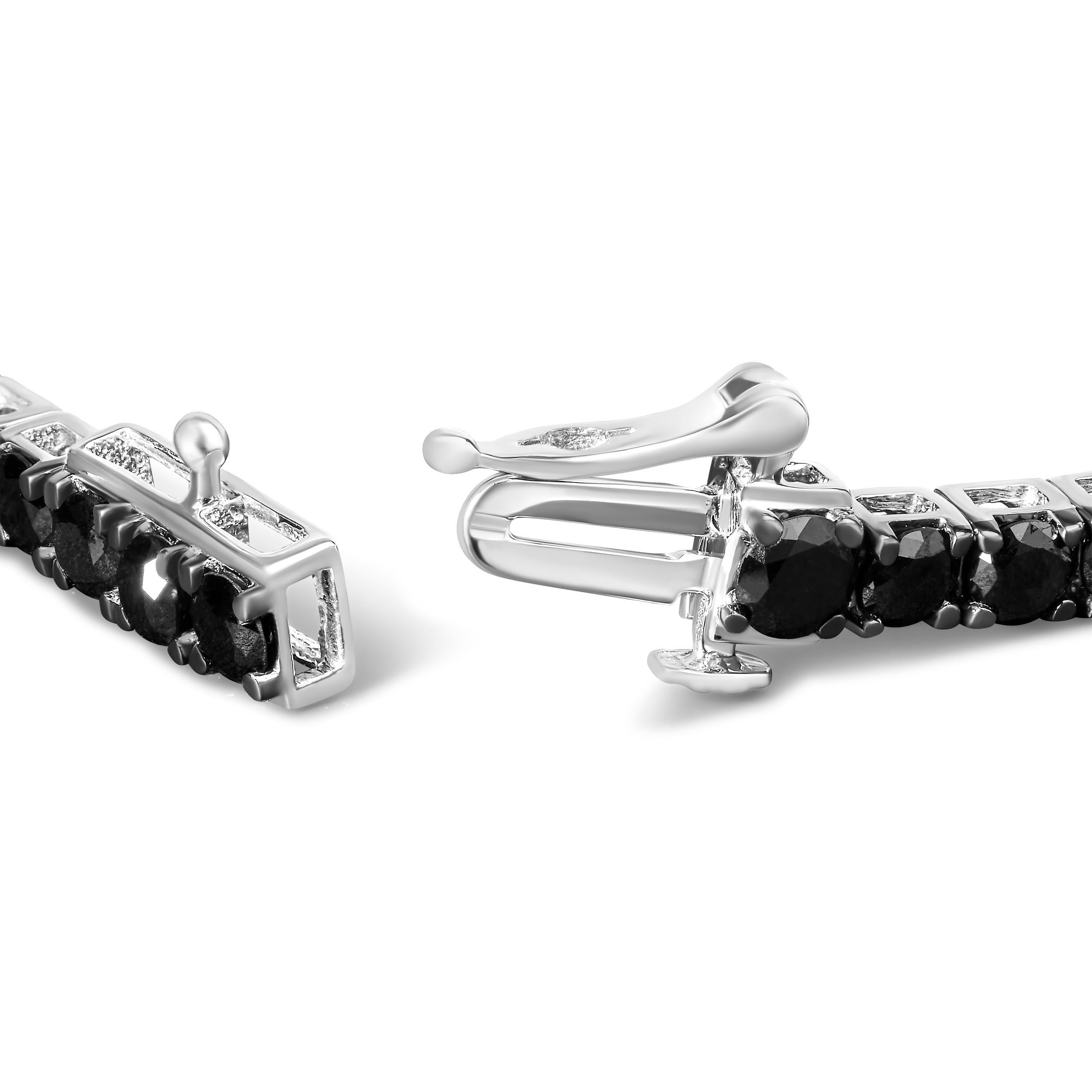 Elegant and timeless, this gorgeous .925 sterling tennis bracelet features 6.0 carat total weight of natural round brilliant cut treated black diamonds with a whopping 56 individual stones in all. The tennis bracelet has hinged links consisting of a