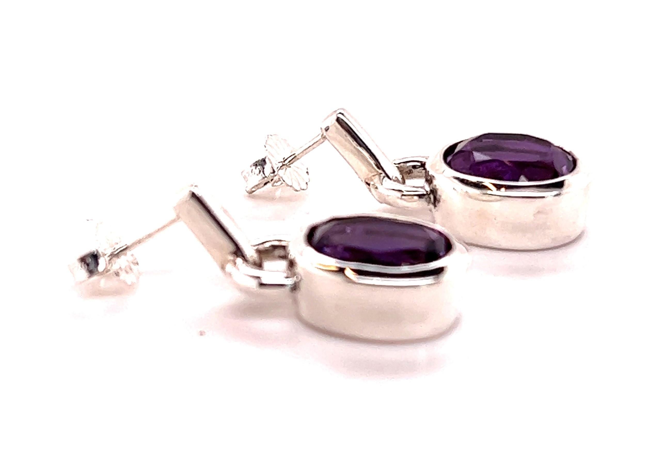 Are you looking for earrings with a big look without paying an arm and a leg? These amethyst earrings fit that bill nicely!

The earrings boast oval cut, bezel set amethysts weighing in at approximately 6.78Carats. The amethyst bezels are suspended