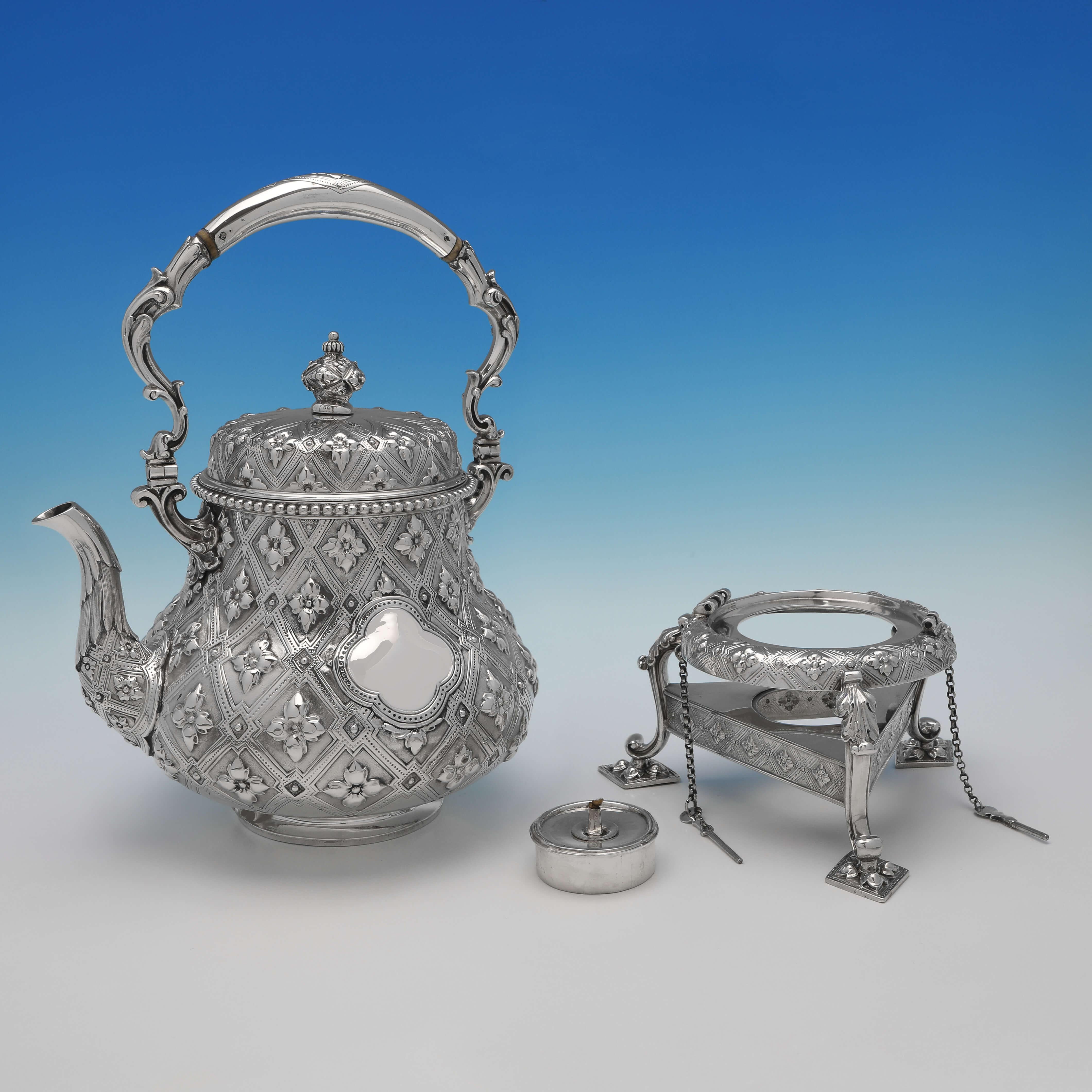 Hallmarked in London in 1861 and 1862 by Robert Hennell I, this striking, Victorian, Antique Sterling Silver Tea Set, includes a covered milk jug and a small cream jug, and features wonderfully ornate chasing throughout, and silver handles. The