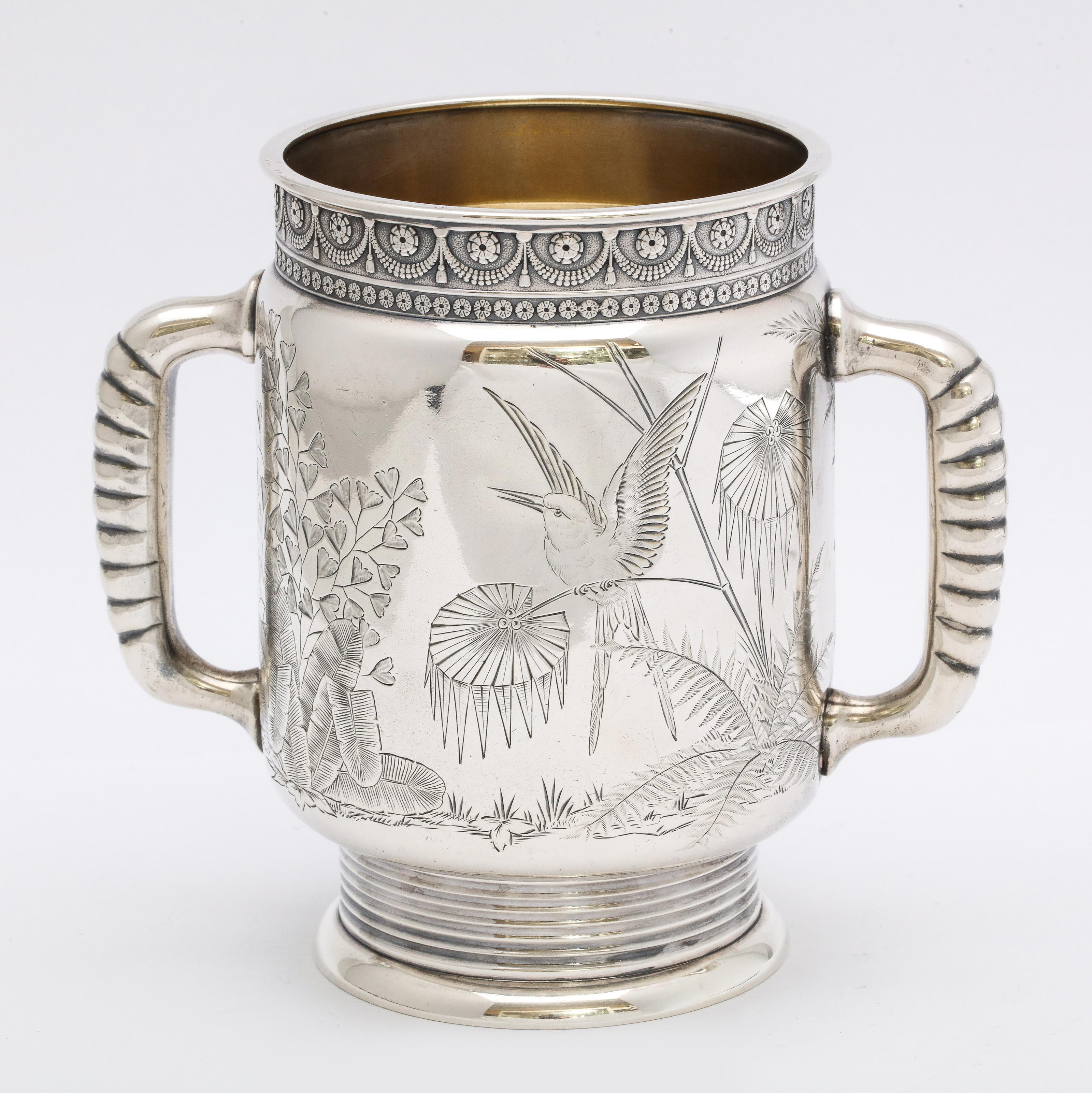 Aesthetic Movement, sterling silver, two-handled mug, Gorham Manufacturing Co., Providence, Rhode Island, year hallmarked for 1878. Lovely etched designs. One side has an etched butterfly flitting among ferns; the opposite side of the mug has an