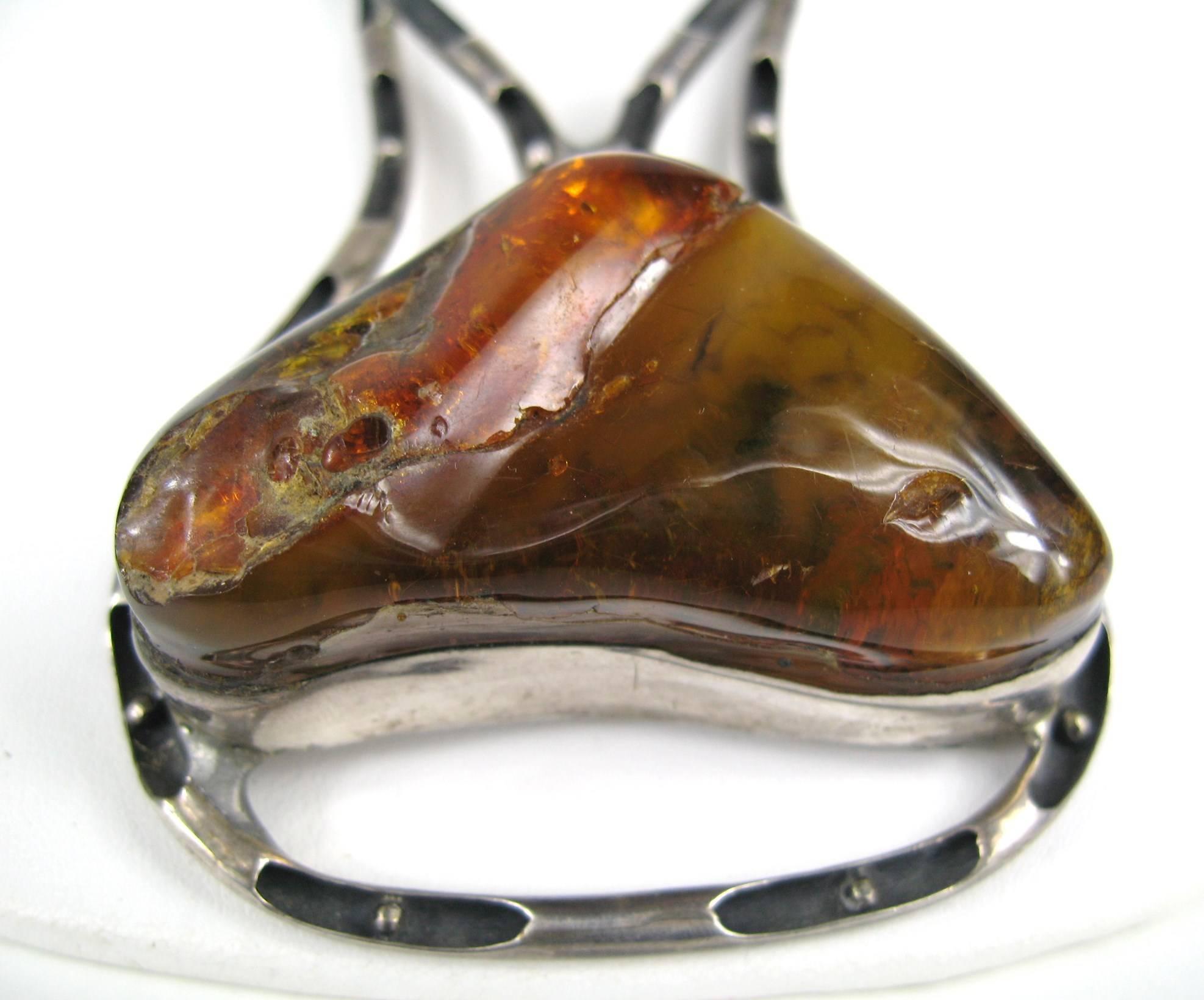 Massive Artisan Sterling Silver necklace with a huge chunk of Amber. Hand Crafted one of kind piece of jewelry Necklace drops to 30 in. Large links make up most of necklace which turns into a fixed link with hook closure. Amber measures