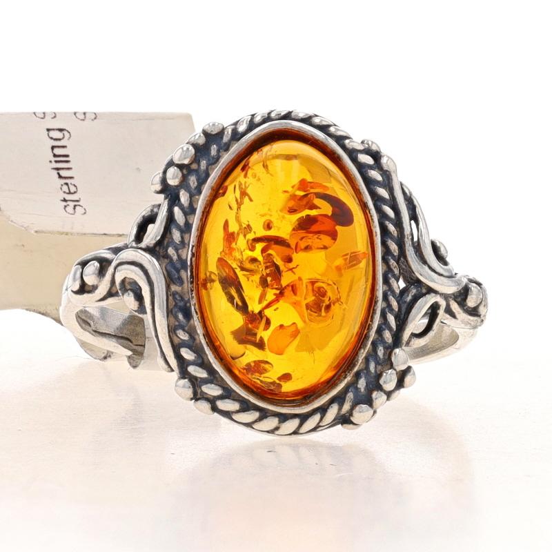 Size: 7
Sizing Fee: Up 2 sizes for $20 or Down 2 sizes for $20

Metal Content: Sterling Silver

Stone Information
Natural Amber
Cut: Oval Cabochon
Color: Orange

Style: Cocktail Solitaire

Measurements
Face Height (north to south): 5/8