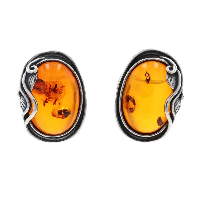 Metal Content: Sterling Silver

Stone Information
Genuine Amber
Cut: Oval Cabochon
Color: Orange

Style: Large Stud 
Fastening Type: Butterfly Closures
Theme: Leaves

Measurements
Tall: 29/32