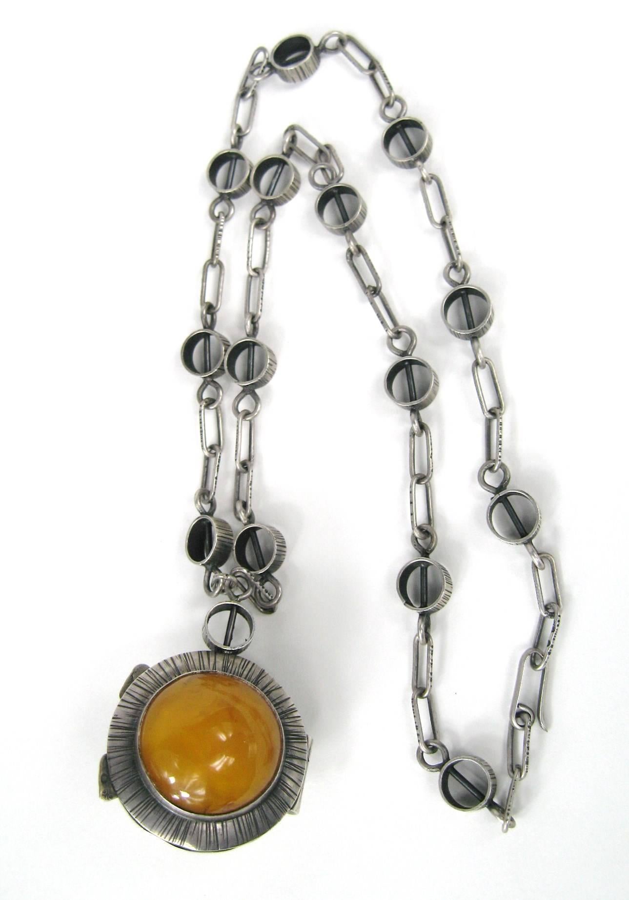 This is amazing, double sided amber locket. It is Hallmarked on the lock on the locket. Has a Link chain. The Locket in 1.49 inches in diameter. 24.5 inches  end to end on link chain. This is out of a massive collection of Hopi, Zuni, Navajo,