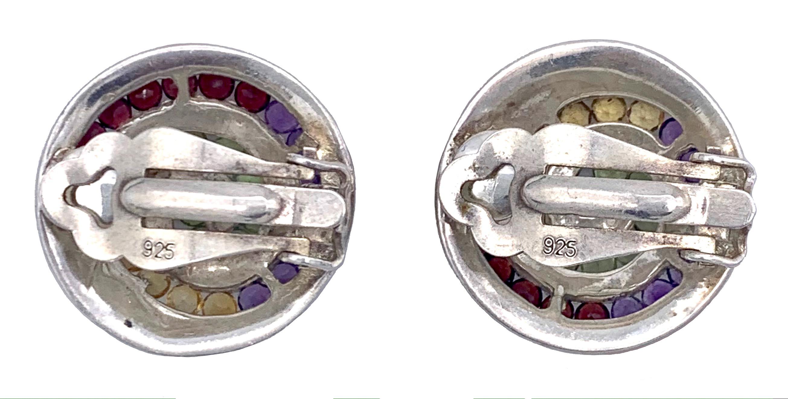 The Sterling siver ear clips are decorated with a spiral motive set with garnets, amethysts, citrines and peridots.