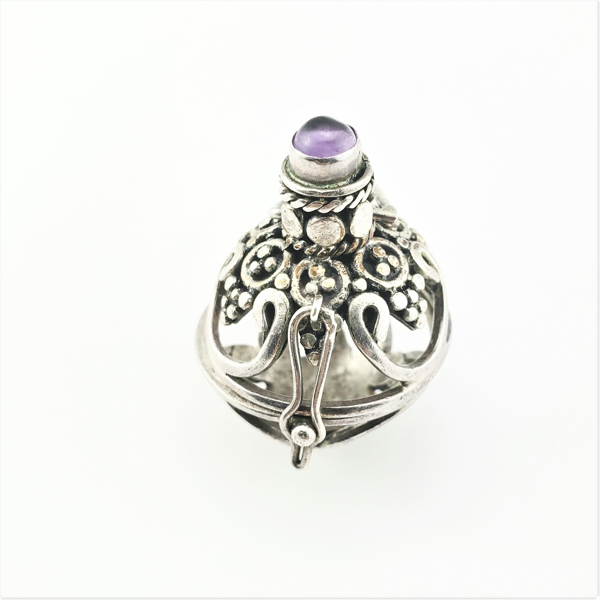 Vintage Sterling Silver Amethyst Harmony Ball Locket Pendant-

This lovely hinged harmony ball locket is accented with one amethyst stone (5 mm) and crafted in beautifully detailed sterling silver.

Size: 2 1/4 inches length

Diameter: 23