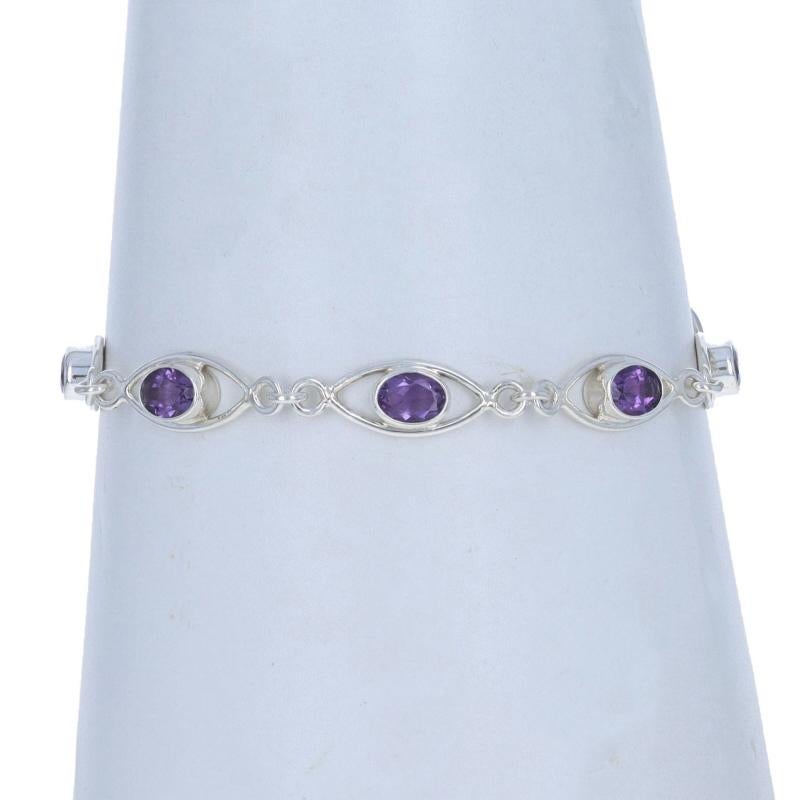 Metal Content: Sterling Silver

Stone Information

Natural Amethysts
Carat(s): 5.10ctw
Cut: Oval
Color: Purple

Total Carats: 5.10ctw

Style: Link
Fastening Type: Toggle Clasp
Features: Open Cut Design

Measurements

Adjustable length: 7 1/2