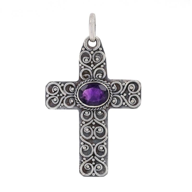 Metal Content: 925 Sterling Silver

Stone Information

Natural Amethyst
Carat(s): 2.40ct
Cut: Oval
Color: Purple

Total Carats: 2.40ct

Theme: Scrollwork Cross, Faith

Measurements

Tall (from stationary bail): 1 13/16