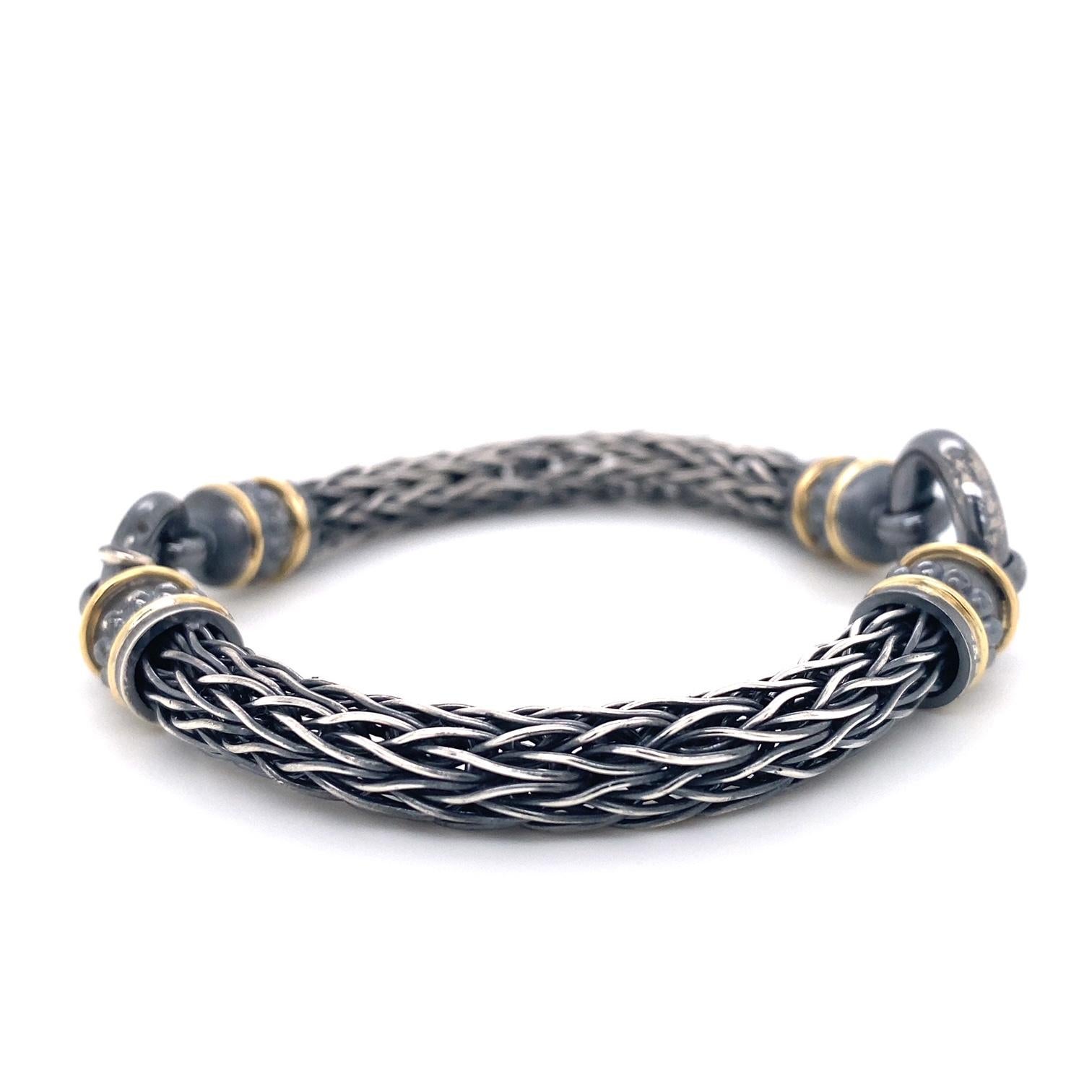 An oxidized sterling silver and 18k yellow gold roman chain style bracelet,  7.75 inches in length. This bracelet was made and designed by llyn strong.