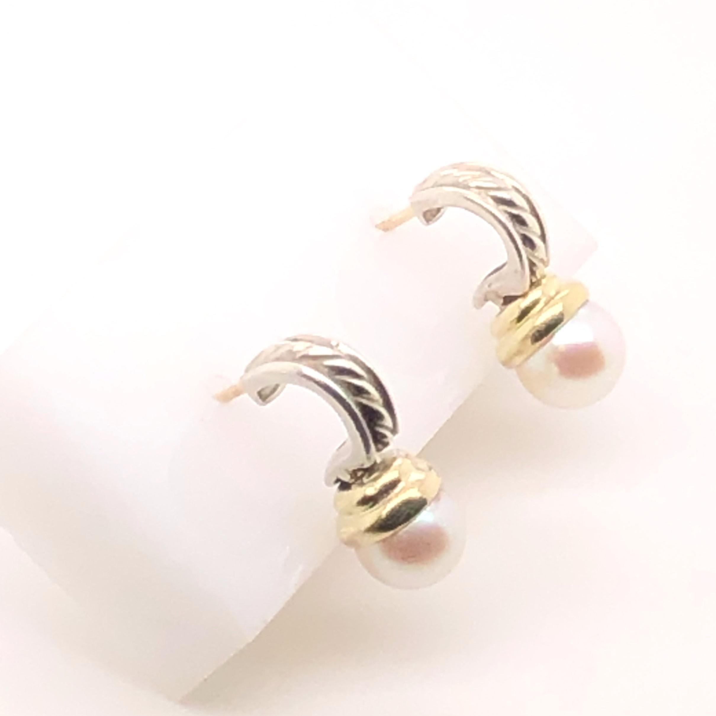 Sterling Silver with 18kt yellow gold David Yurman earrings with round white pearls. The top portion is a half hoop with the inside and outside of polished silver and David Yurman's classic cable inside. Suspended from the half hoops are one each