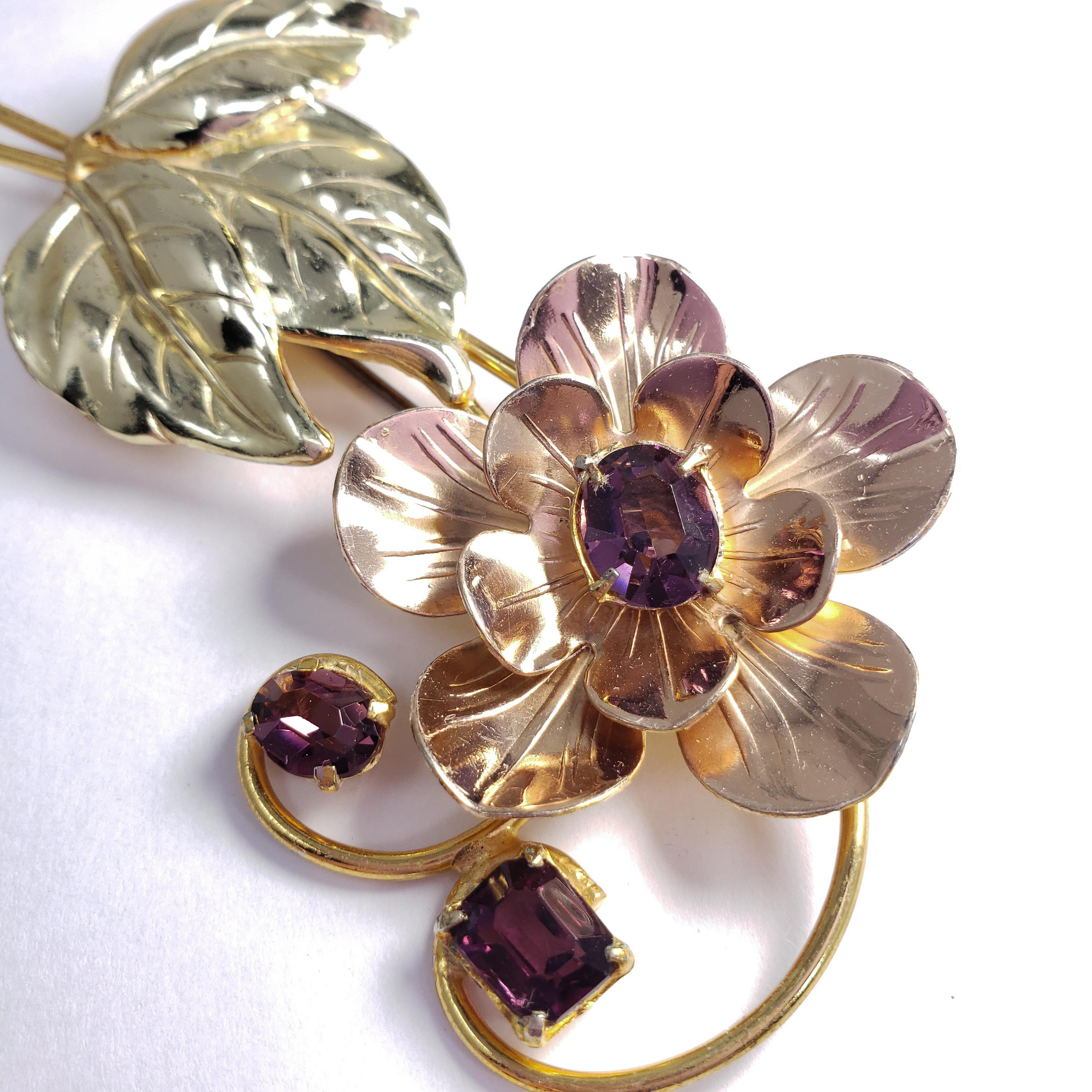 A sterling silver (vermeil & gilt) pin brooch, featuring a leafed flower, accented with purple prong-set crystals. A vintage collector's piece in wonderful condition!

Hallmarks: Sterling