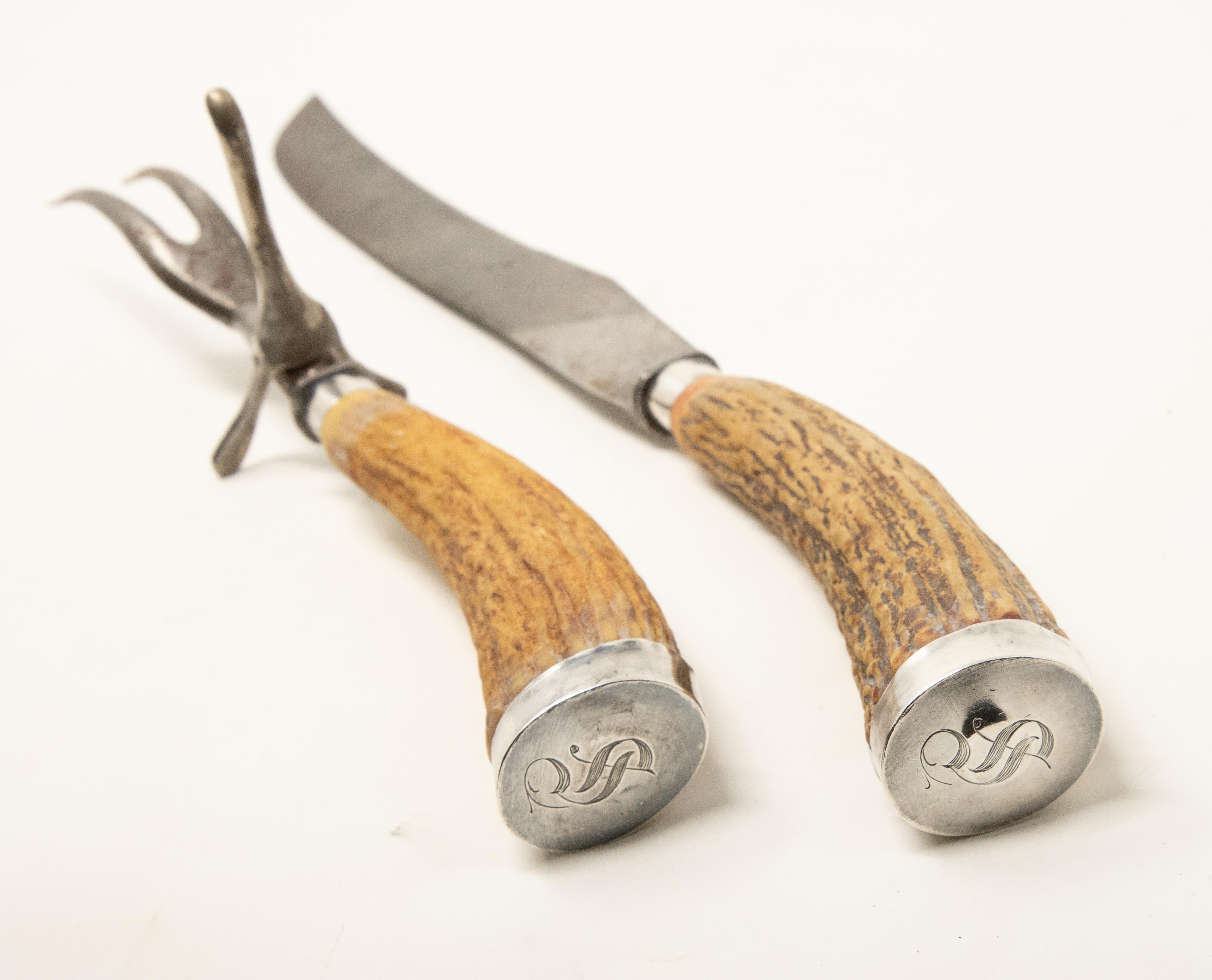 Offering this stunning pair of sterling silver and antler handle carving set. The ends of the antlers are covered in a sterling silver cap with the letter S engraved, and they are marked sterling.