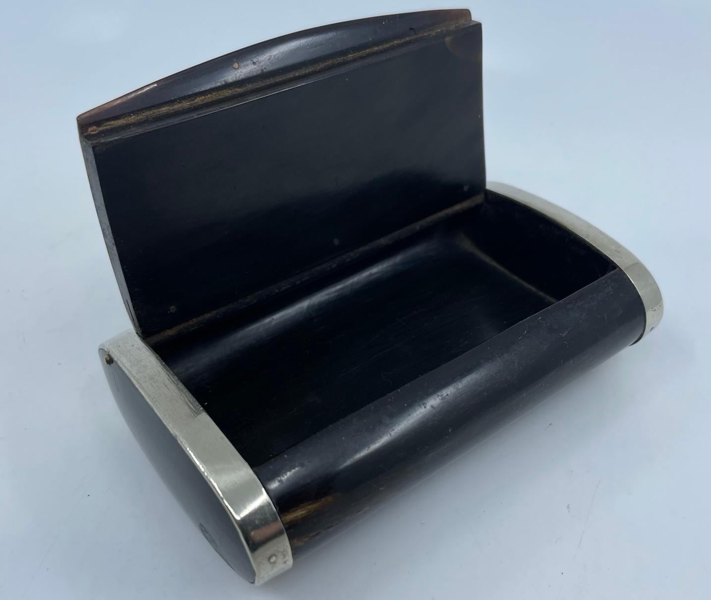 Sterling silver and bone box. Antique Continental dark bone/horn fitted case with sterling silver mounts and central oval for monogram; originally a tobacco and cigarette case. Handsome desk accessory. Europe, mid 19th century

Dimensions: 4.25” L