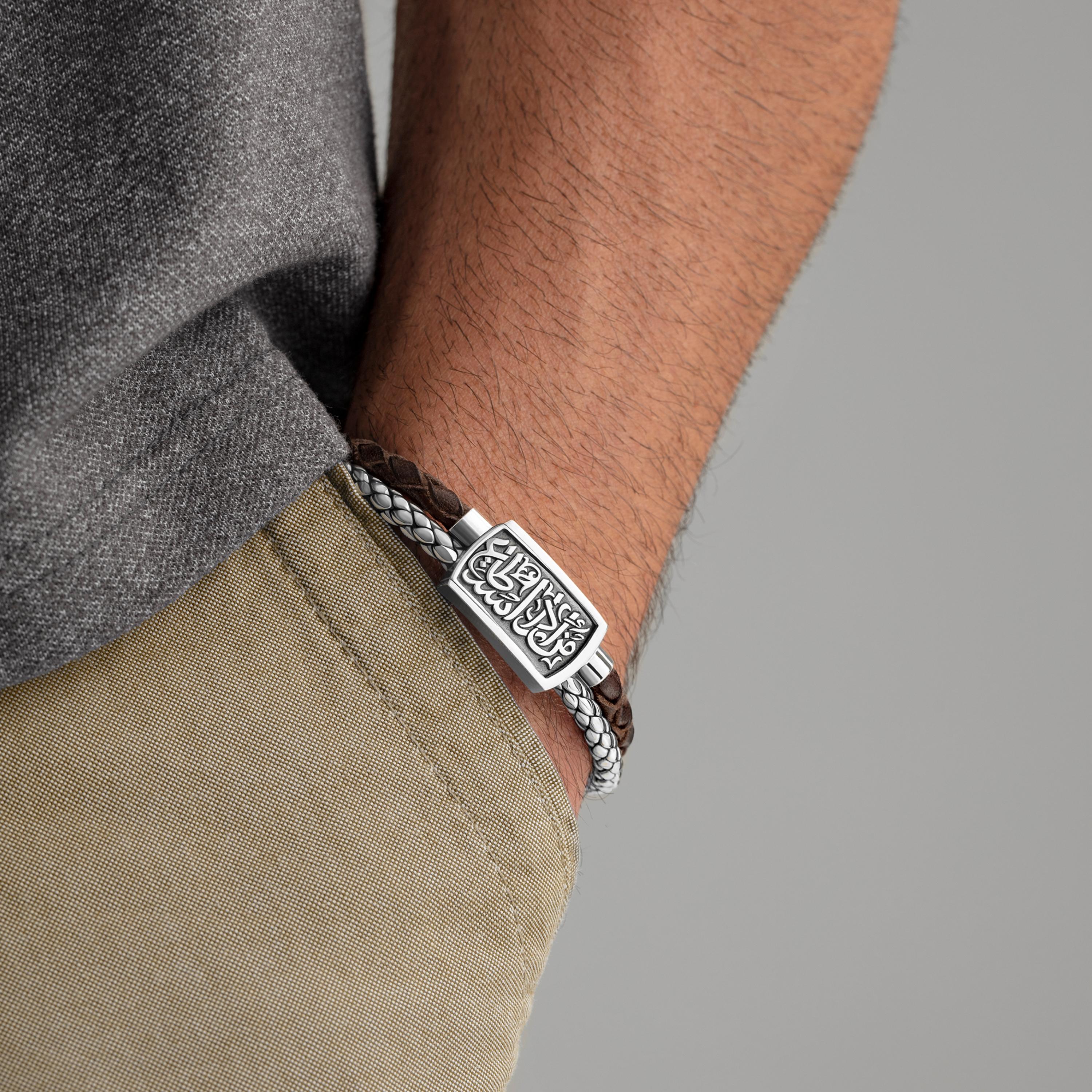 Sterling Silver and Braided Leather Slide-on Bracelet inscribed with Azza Fahmy's signature calligraphy. This bracelet is handcrafted using twisted leather and Sterling Silver-cast twisted leather. The plate atop the bracelet is inscribed with
