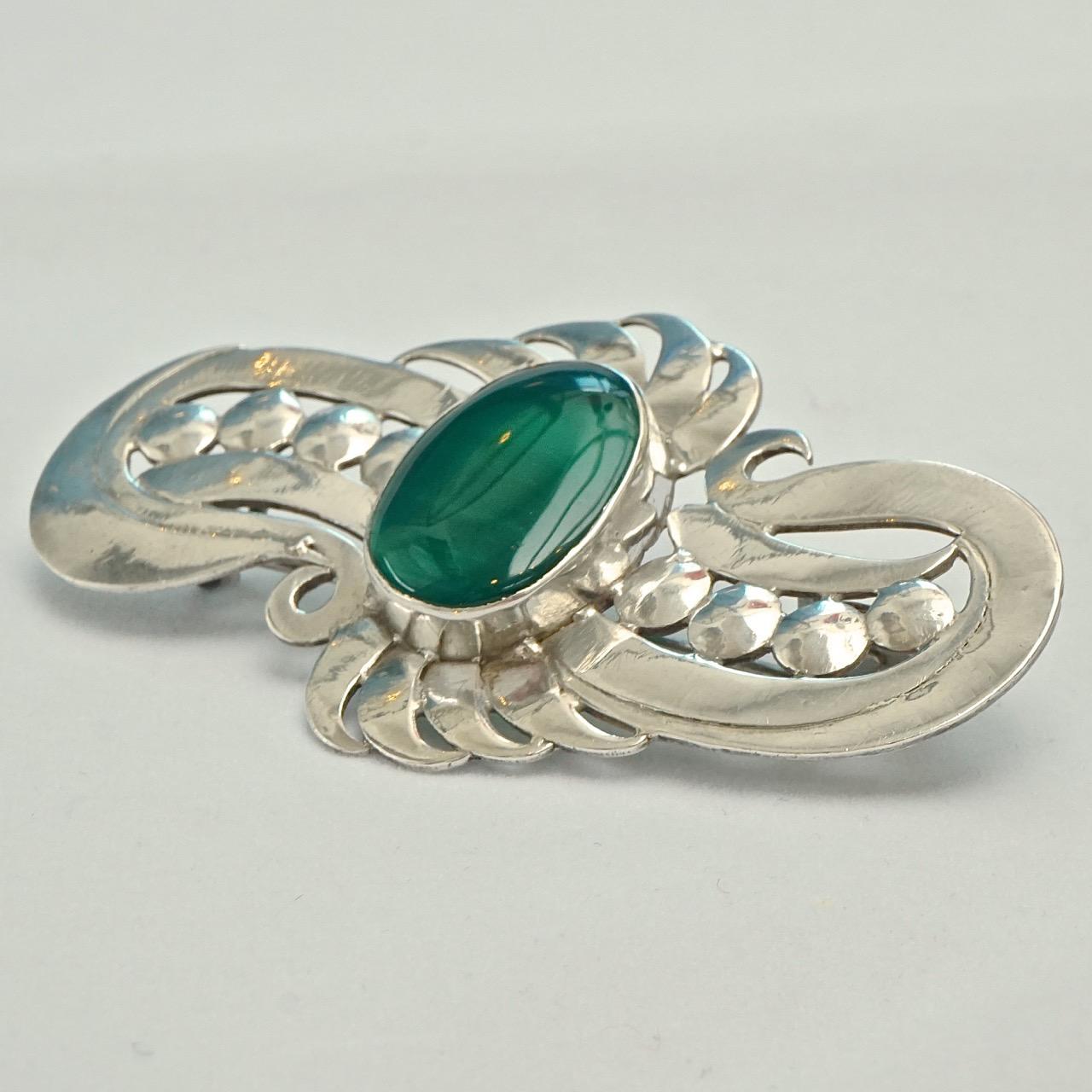 
Wonderful sterling silver hand crafted brooch, featuring an oval chrysoprase. This lovely brooch tests for silver and is stamped 925. Measuring length 7.2cm / 2.8 inches by width 4cm / 1.5 inches. The brooch is in very good condition.

This is a