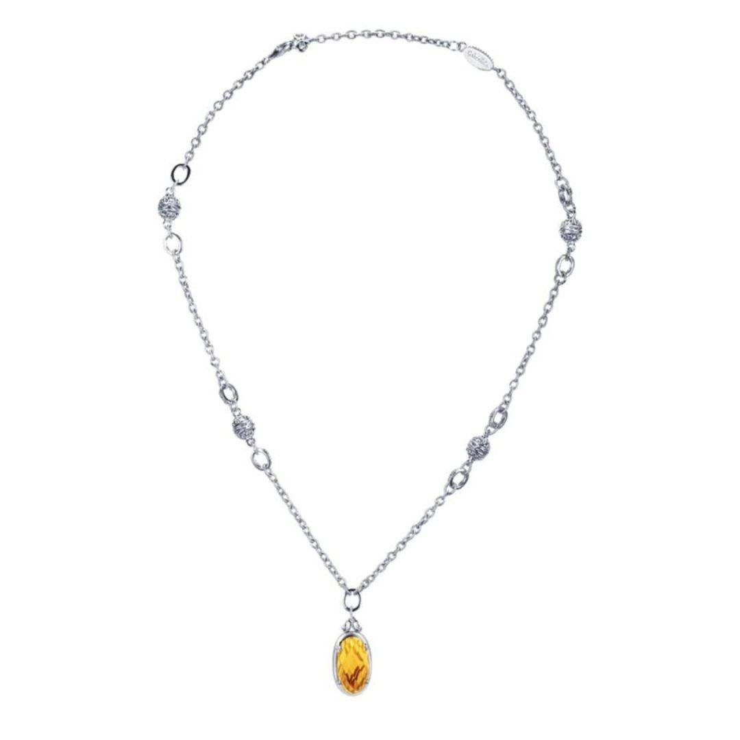 Sterling Silver and Citrine Pendant. A beautiful oval faceted citrine weighing 7.89 carats is bezel set and suspended from a fancy filigree chain. Chain is 18