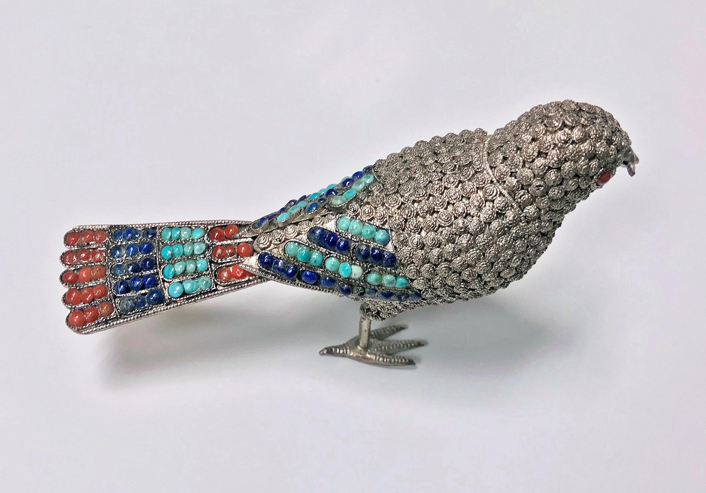 925 sterling silver and multi-color stone bird (possibly a fantail), probably Chinese, circa 1950. The bird with fish in mouth is highly detailed with a fine silver wire work filigree body, inset with stones. The silver tail, wings and eyes set with