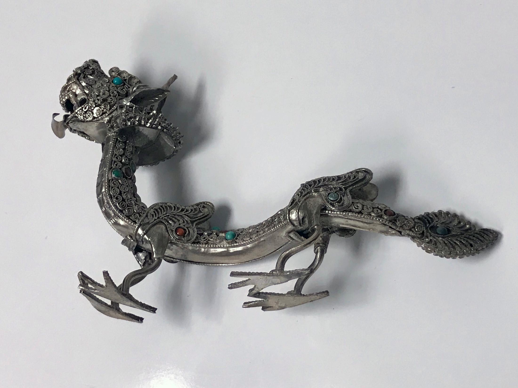 925 Sterling silver and multi-color stone inlay standing Dragon, probably Chinese, circa 1950. The dragon is highly detailed with a Fine silver wire work filigree body, wings, hands and claw feet. The silver set with numerous orange and turquoise