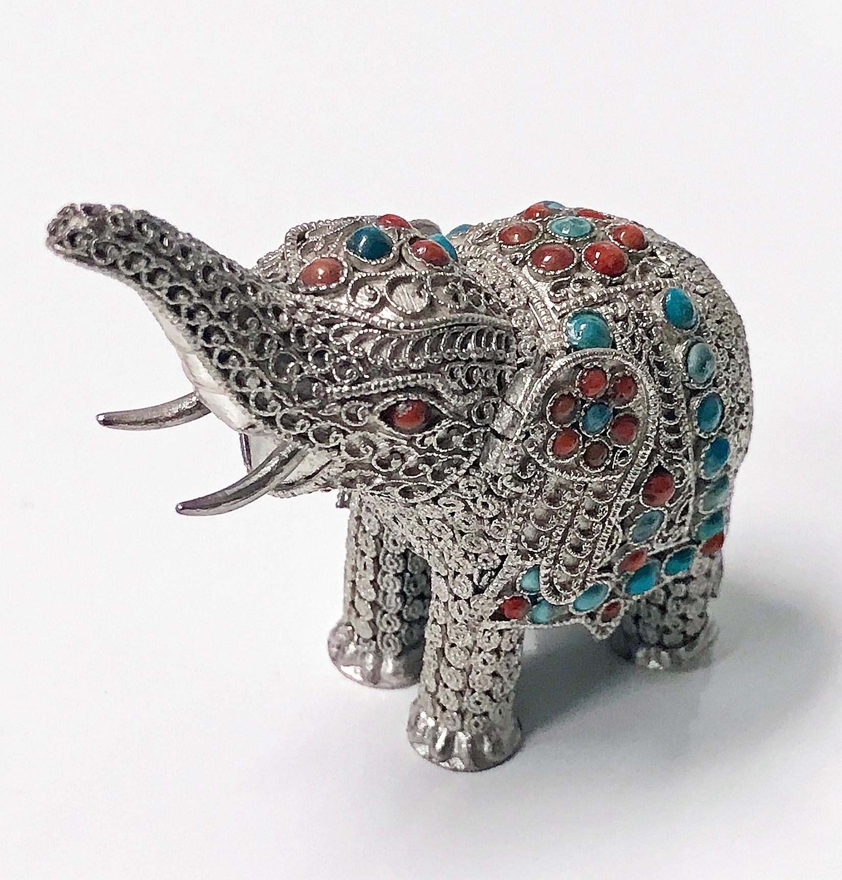 925 sterling silver and multi-color stone inlay 'lucky’ elephant with upturned trunk, probably Chinese, circa 1950. The elephant is highly detailed with a fine silver wire work filigree body, inset with stones. The silver set with numerous coral and