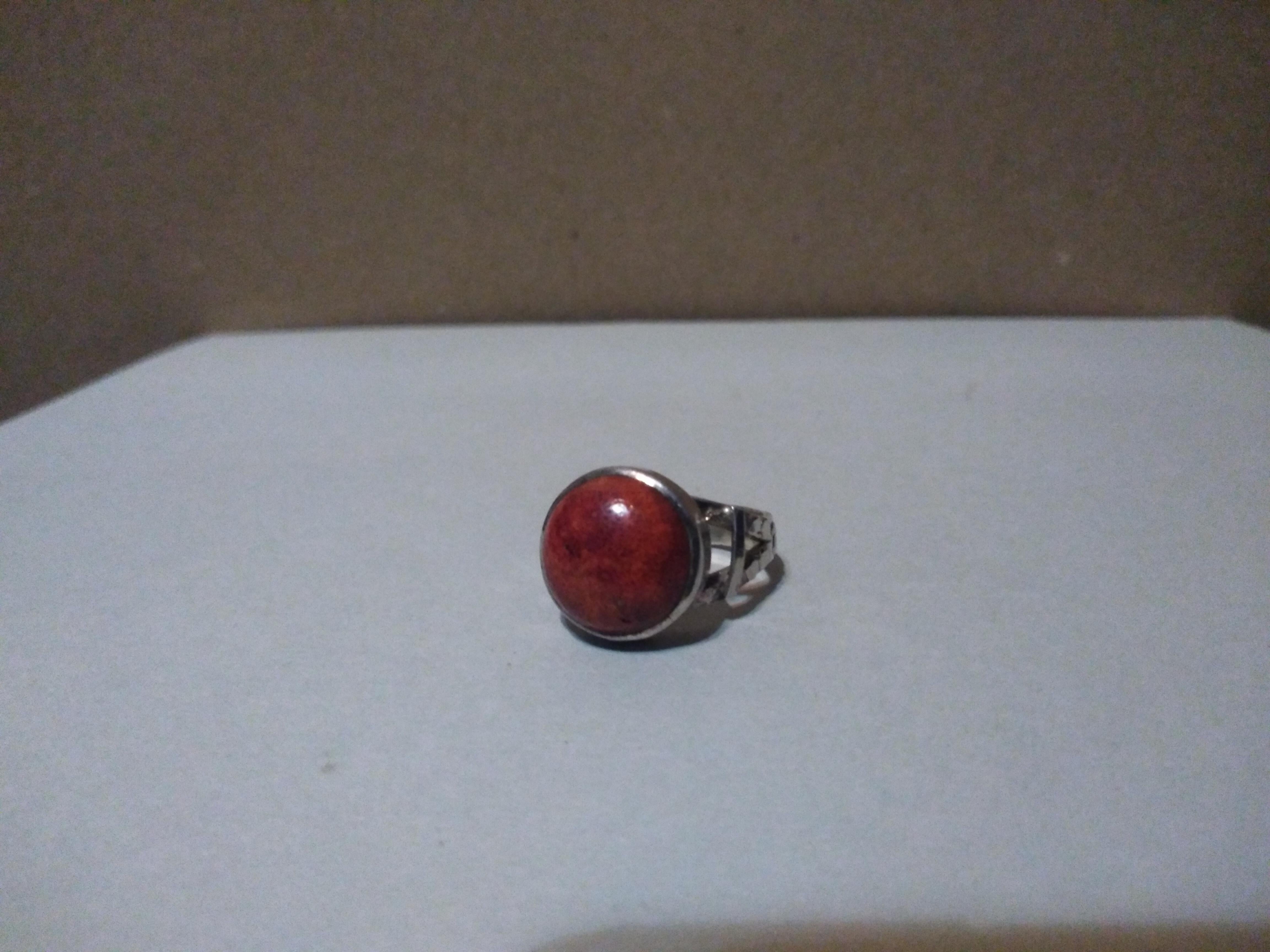 This is a beautiful sterling silver ring with a coral setting. It's a size 8. It's stamped.925