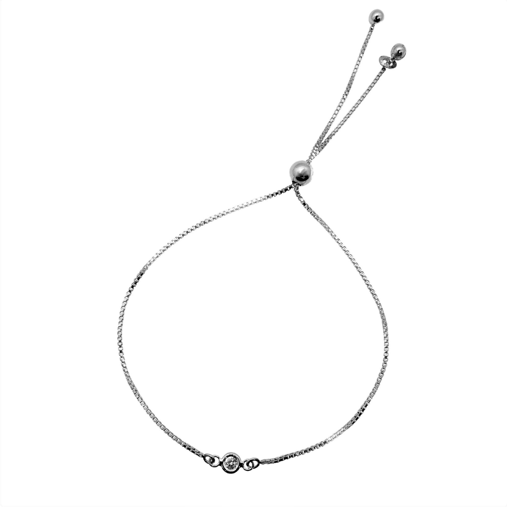 Brilliant easy to wear stackable sterling silver bracelet with a center Diamond set in a Silver bagel bezel. Very chic especially worn in multiples.  A main large sliding silver bead can enlarge or reduce the wrist size of the box chain to perfectly
