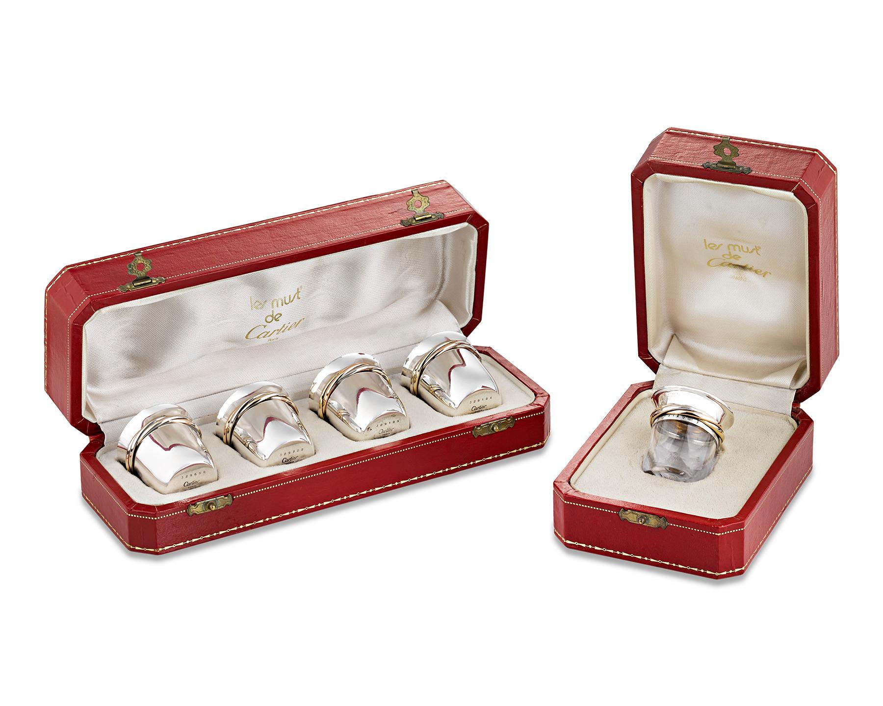 This sterling silver tequila set by Cartier boasts a sleek and stylish design. A striking twist of silver and gold gilt ribbons entwine on the lip of each glass. The streamlined set comprises four sterling silver shot glasses and one glass salt