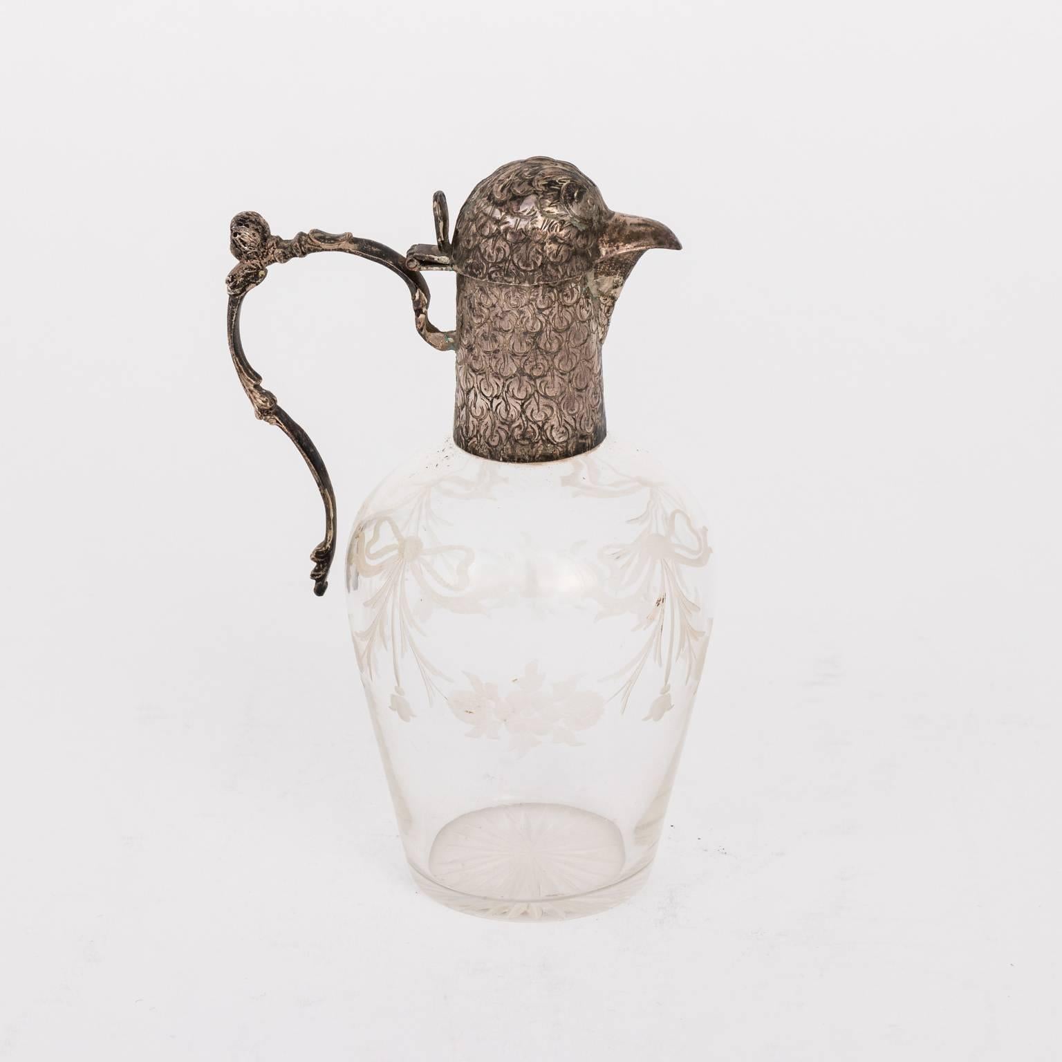 Decanter from the Netherlands with etched glass and 930 pure sterling silver in the shape of a bird's head and beak with a decorated handle, circa early 20th century.
 