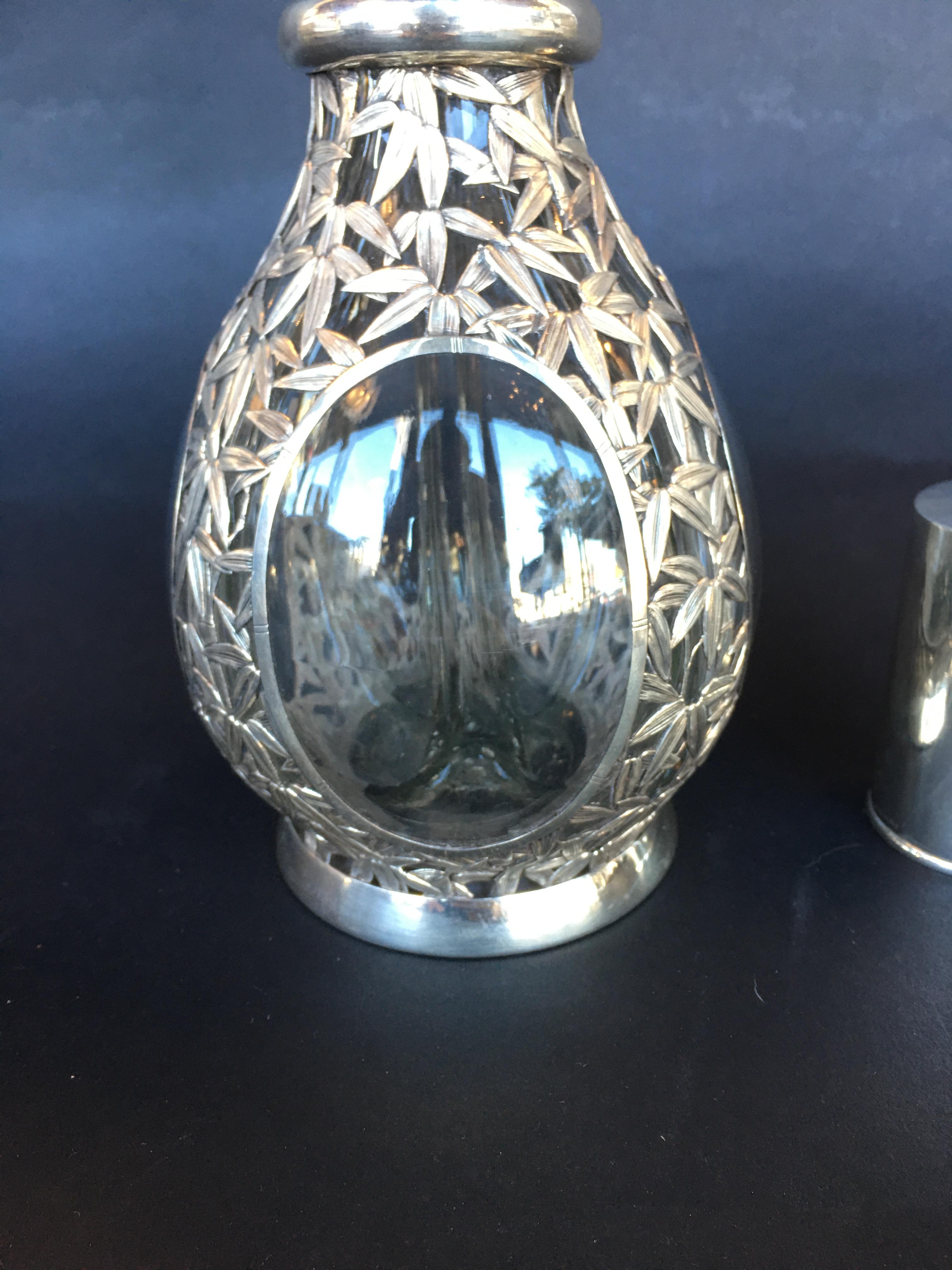 Sterling silver and glass decanter. The decanter has 4 different compartments.