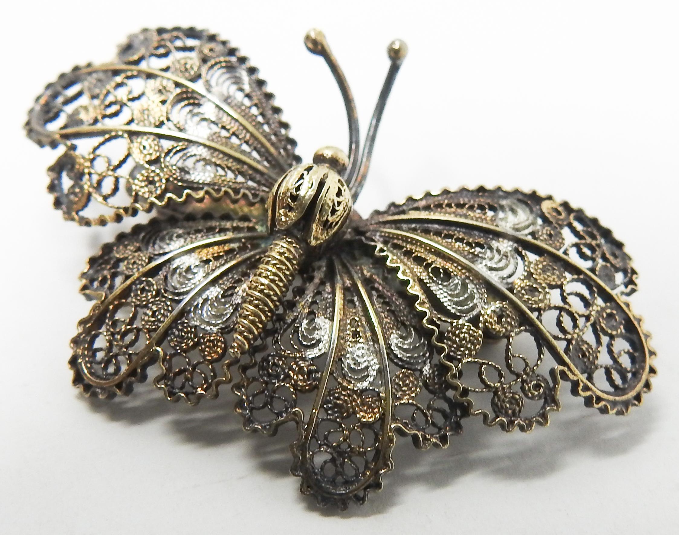 Offering this gorgeous sterling silver and gold filigree butterfly brooch. All the filigree is handcrafted and done in beautiful patterns. The back of the pin is marked Sterling on the pin. No makers mark is visible.