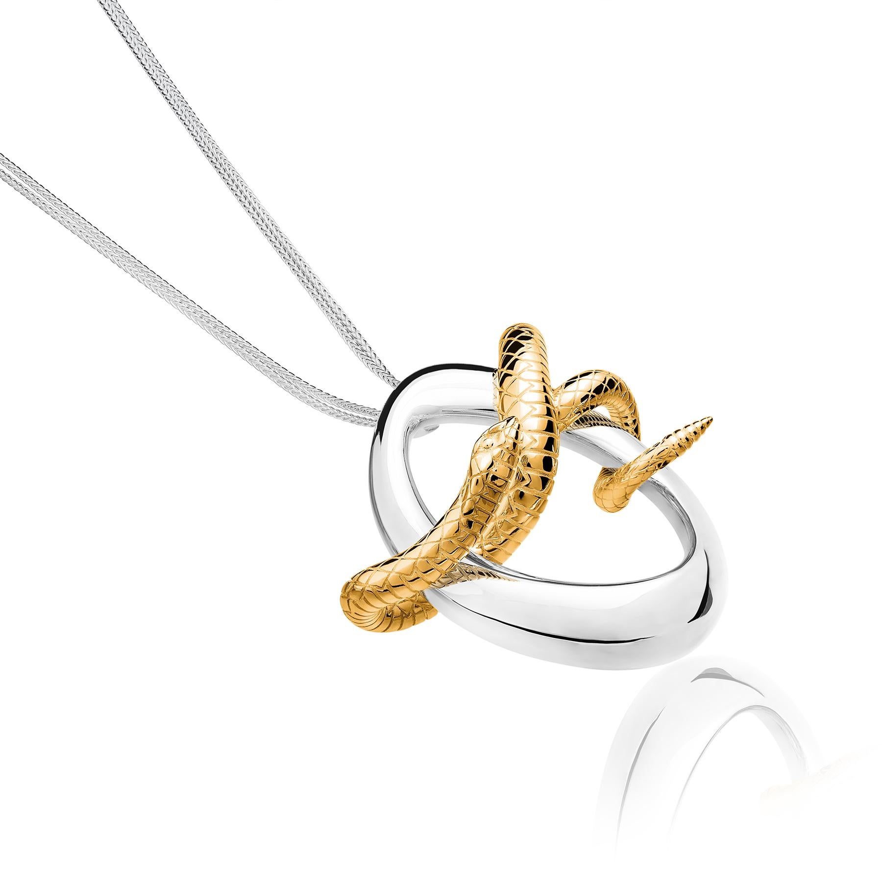 The Serpiente Vermeil Pendant  from the Animales Collection by TANE is made in sterling silver. Suspended from a chain of 31.4”, there is an irregular link designed for the collection, inspired by nature. Through this link, a Serpent is wound