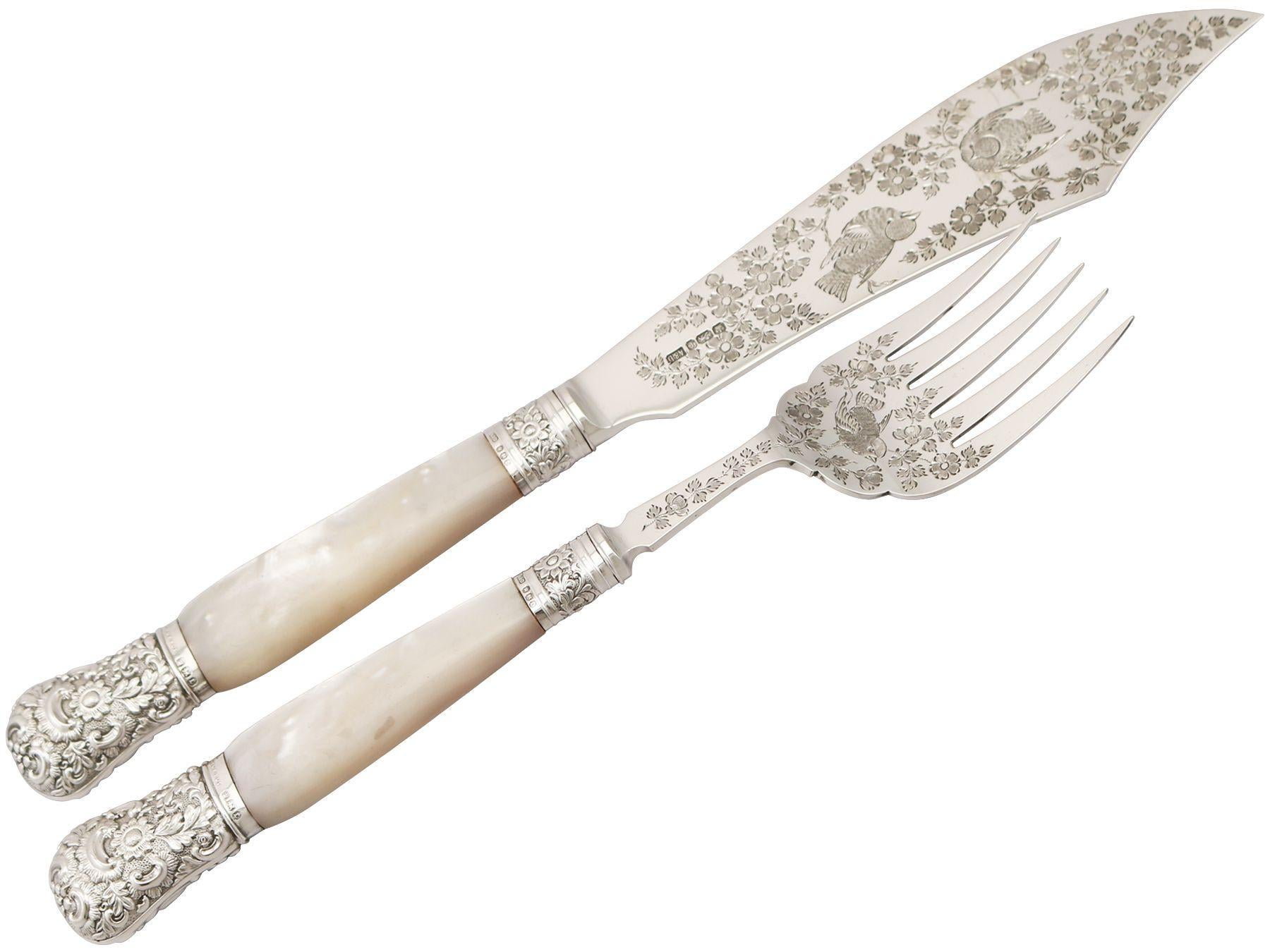 An exceptional, fine and impressive pair of antique Victorian English sterling silver and mother of pearl fish servers - boxed; an addition to our silver flatware collection.

This exceptional pair of antique mother of pearl fish servers consists