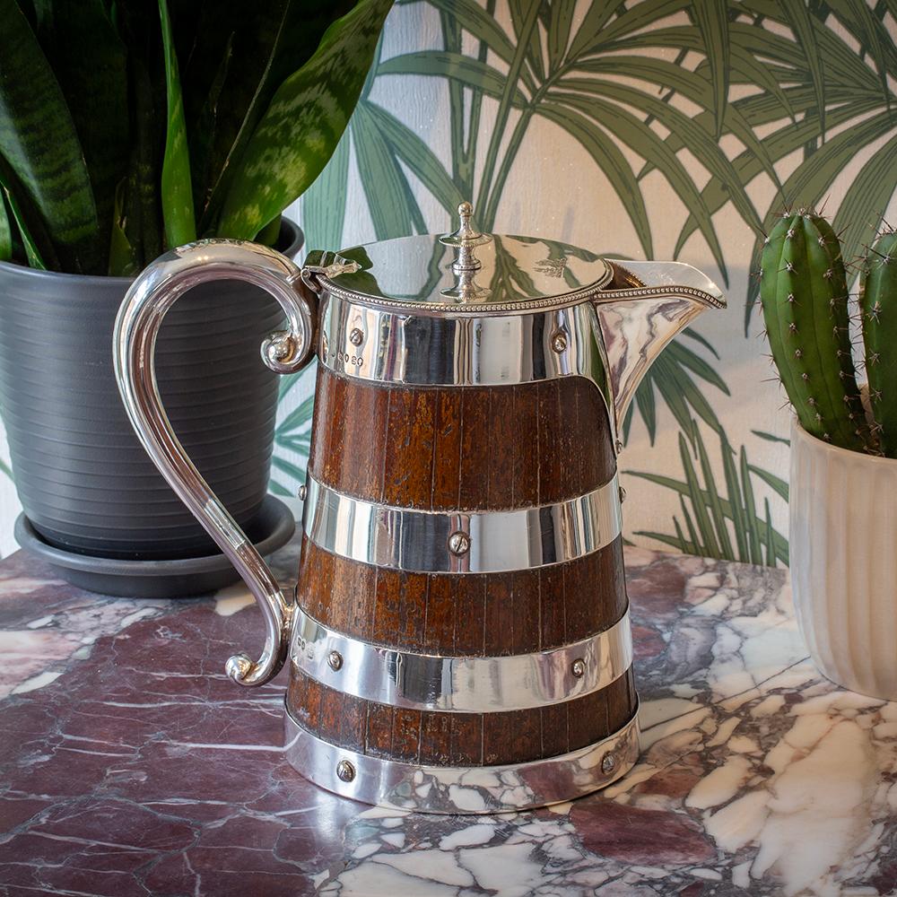 Rare Example Mounted in Sterling Silver

From our Decorative collection we are pleased to offer this Silver and Oak Coopered Jug by Frazer and Haws. The Silver and Oak Jug of good size with oak strips mounted in rare sterling silver strapping