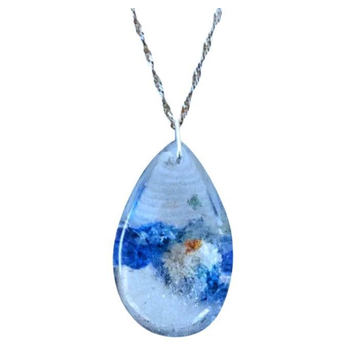 Sterling Silver and Quartz Crystal Pendant Necklace, Blue, White, Orange, Clear. Stamped connector.
This is a pretty pendant, with a cloud-reminiscent quartz central interior of mostly blue and white in a clear crystal teardrop. (the last photo is