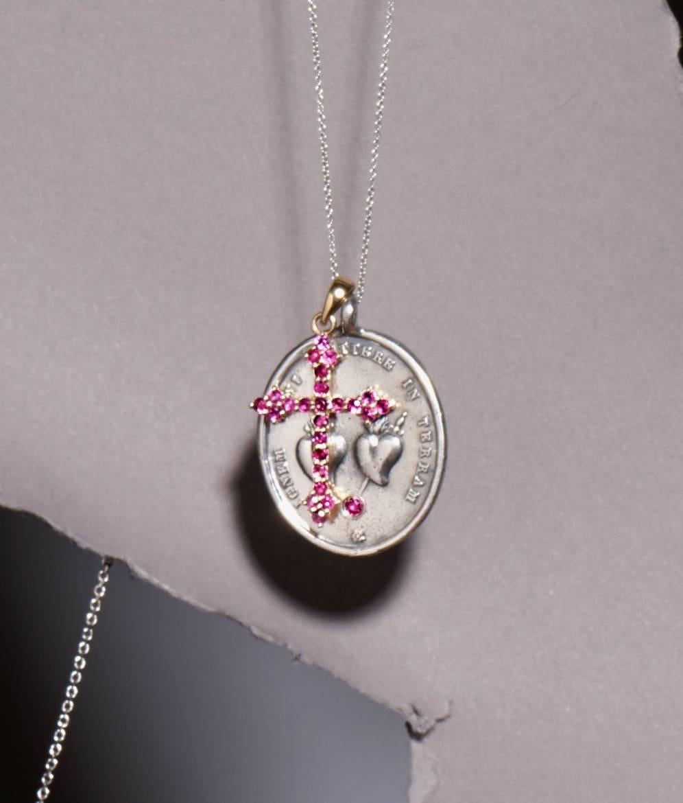 This sterling silver and ruby Sacred Hearts Medallion is cast from an original antique. The Sacred Heart has long been a symbol of Divine love. Above the sacred hearts on the face of the medallion is the Latin inscription: ignem vein mittere in