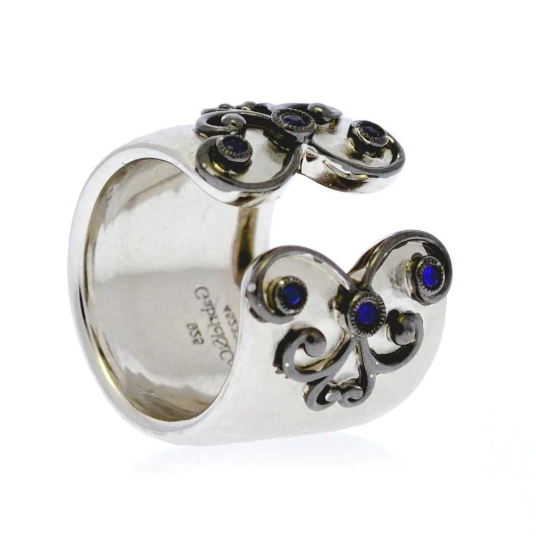 Sterling Silver and Sapphires Ring with Black Rhodium Filigree. One of a kind design opens up in the front. Ring contains 0.15 ctw of gemstone weight. Rhodium plated for tarnish free maintenance.