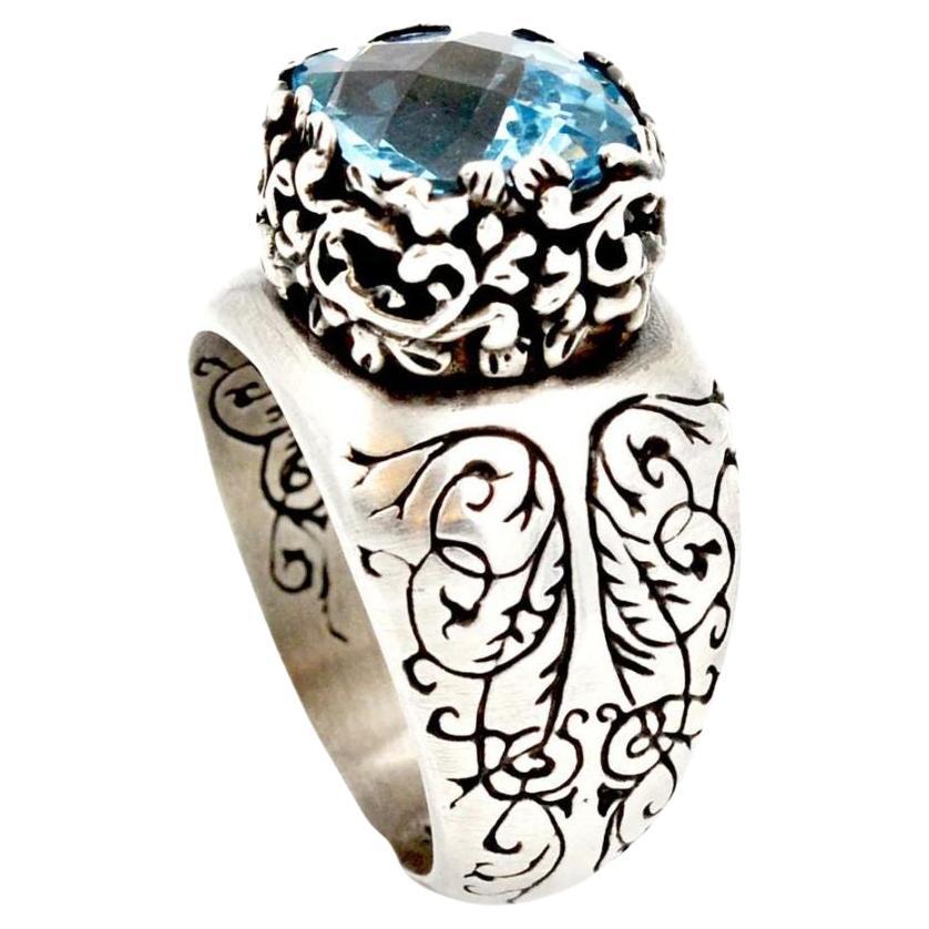 Sterling Silver and Sky Blue Topaz Fashion Ring. This is truly a statement ring! Hand engraved sides with black rhodium finish make this ring playful and unique. Ring is crowned by a 5 carat genuine sky blue topaz with checkerboard pattern in a