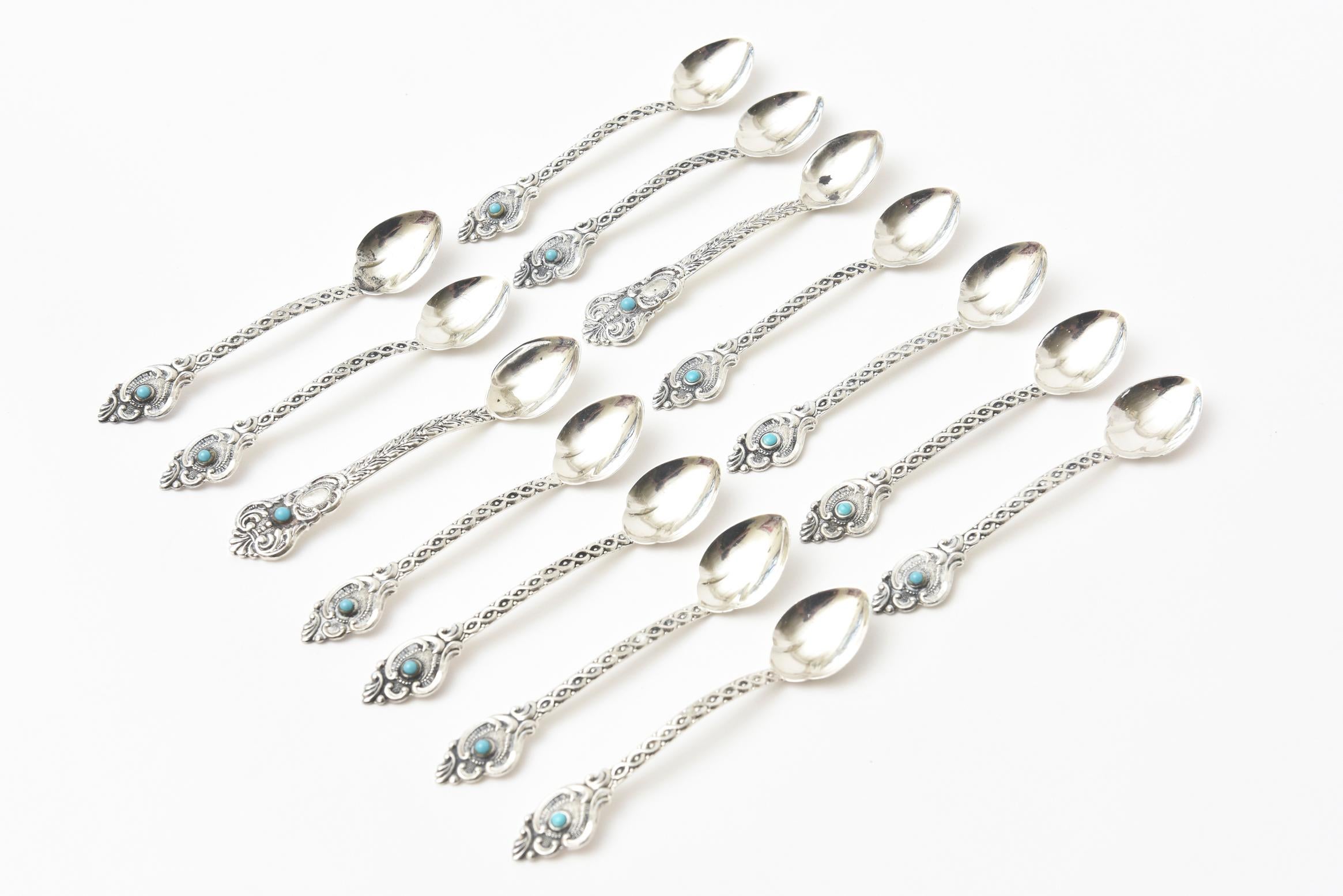 These lovely and regal set of 14 sterling silver and turquoise demitasse, espresso and serving spoons are vintage. They are hallmarked Prata 833 and hand wrought. They are from Brazil and from the 1970s. There are two spoons that weigh more and are