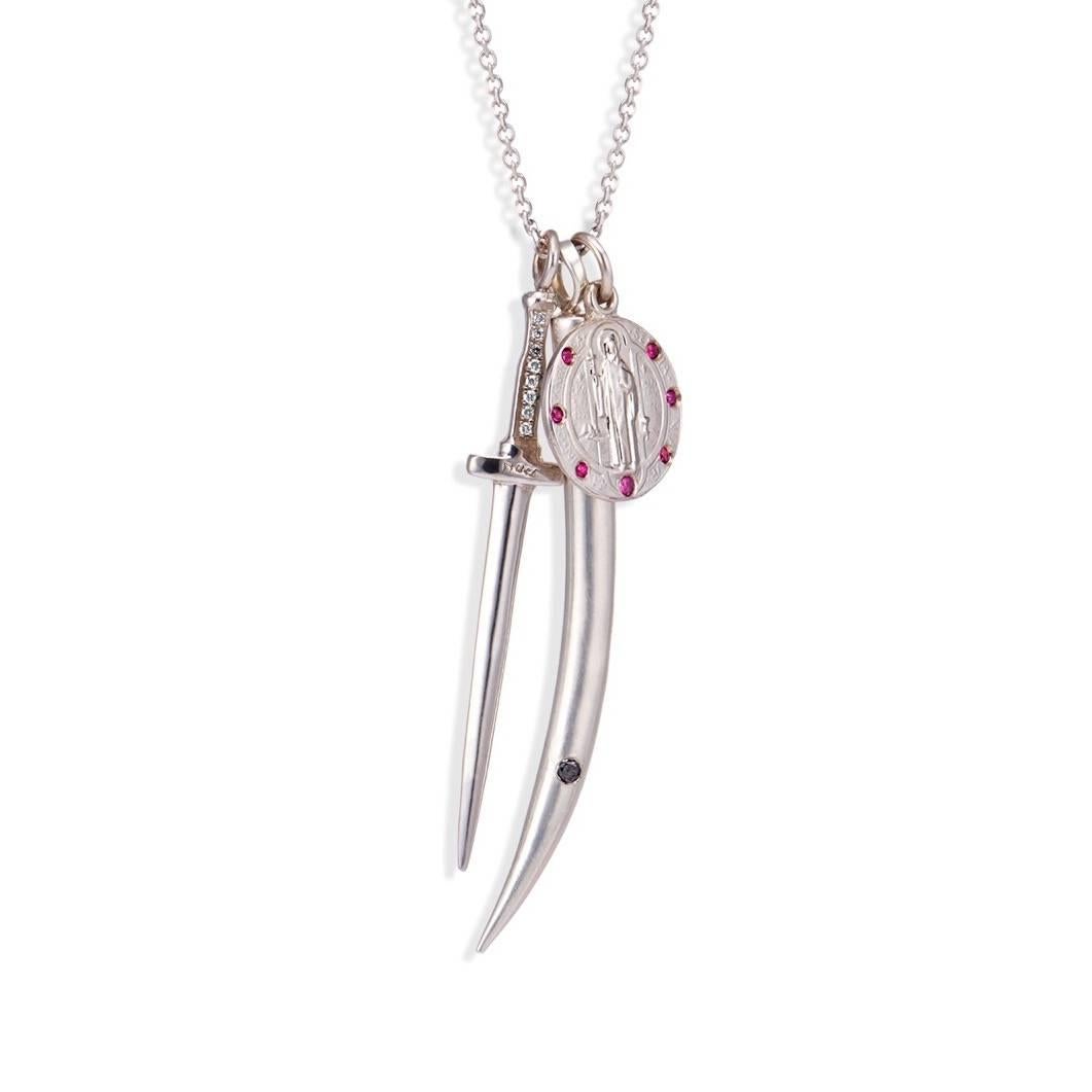 This large sterling silver tusk pendant has a sleek and sexy design meant to be worn long and solo, but equally alluring layered with other pendants.  It has a diamond set at the tip of the tusk to showcase the femininity of the piece.

The Large