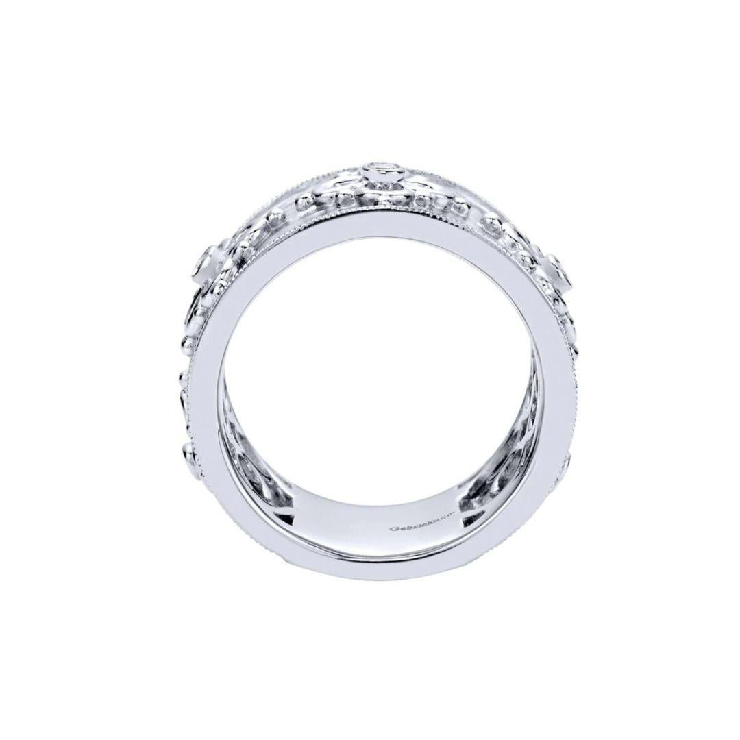 Ladies' Sterling Silver and White Sapphires Fashion Band. Elegant filigree scroll on a hammered finish with embedded genuine white sapphires. Rhodium finish for tarnish free maintenance.Gemstone weight is 0.08 ctw.