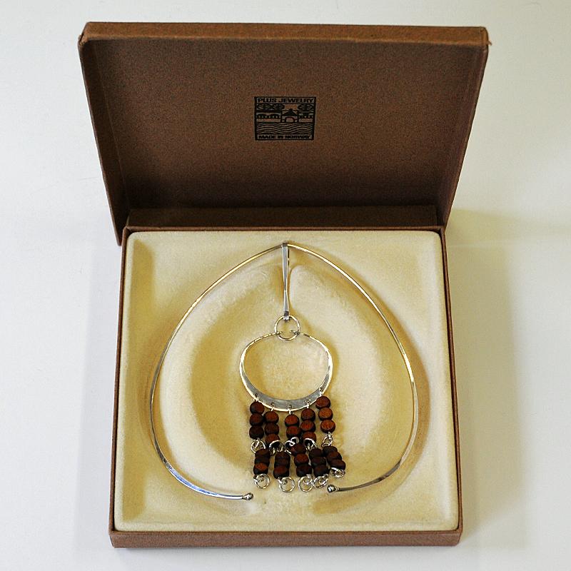 Lovely Scandinavian modern design necklace with four silver and wood dangles. A special vintage pendant by Norwegian silversmith Anna Greta Eker. Manufactured by PLUS Norway. 1960s. This wonderful vintage necklace has double layer with strands of