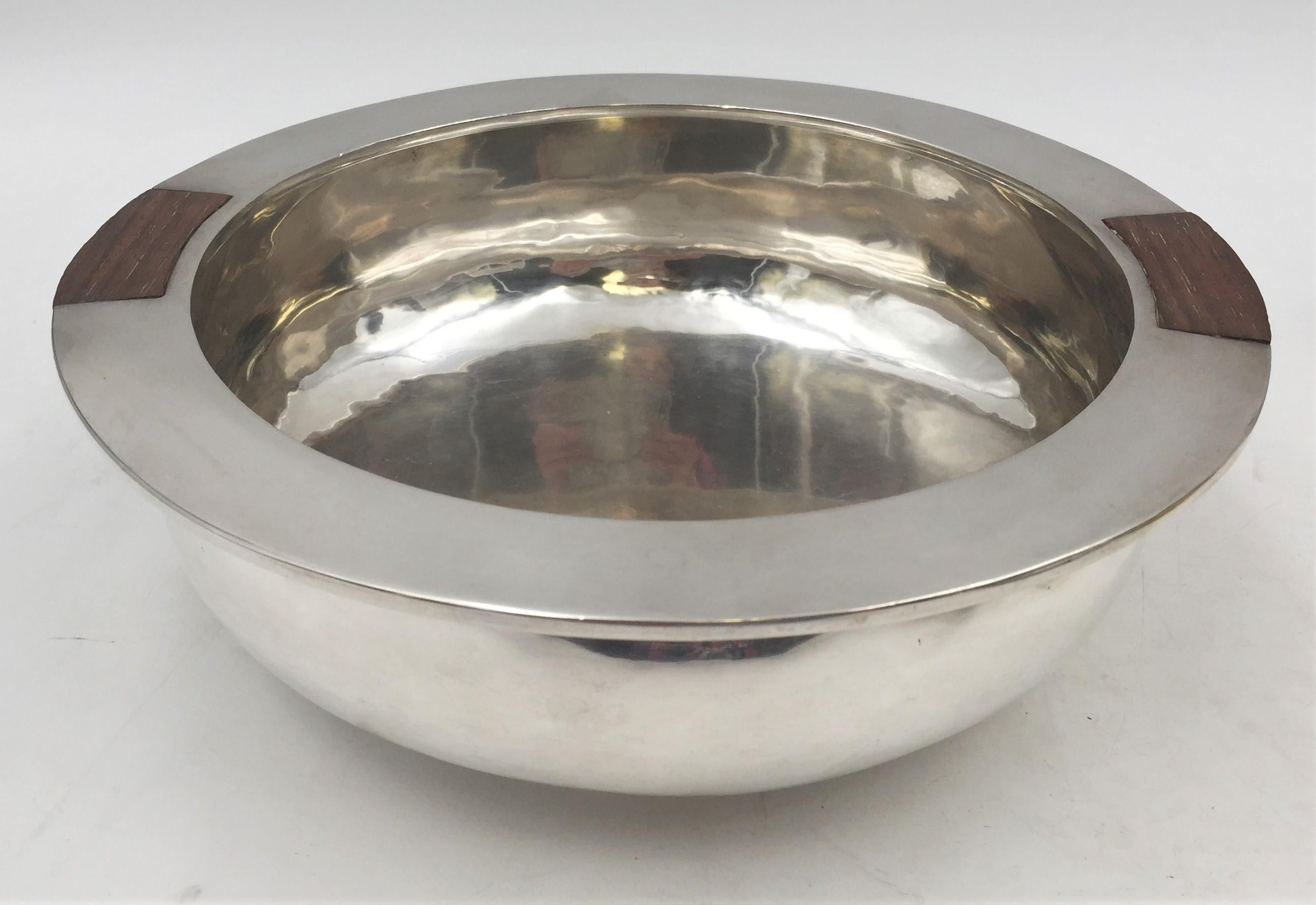 American, 20th century, handmade, sterling silver and wood bowl / ice bucket in Mid-Century Modern style with exquisite geometric design. It measures 8 3/4'' in diameter by 3'' in height, weighs 25 ozt, and bears hallmarks as shown.

 