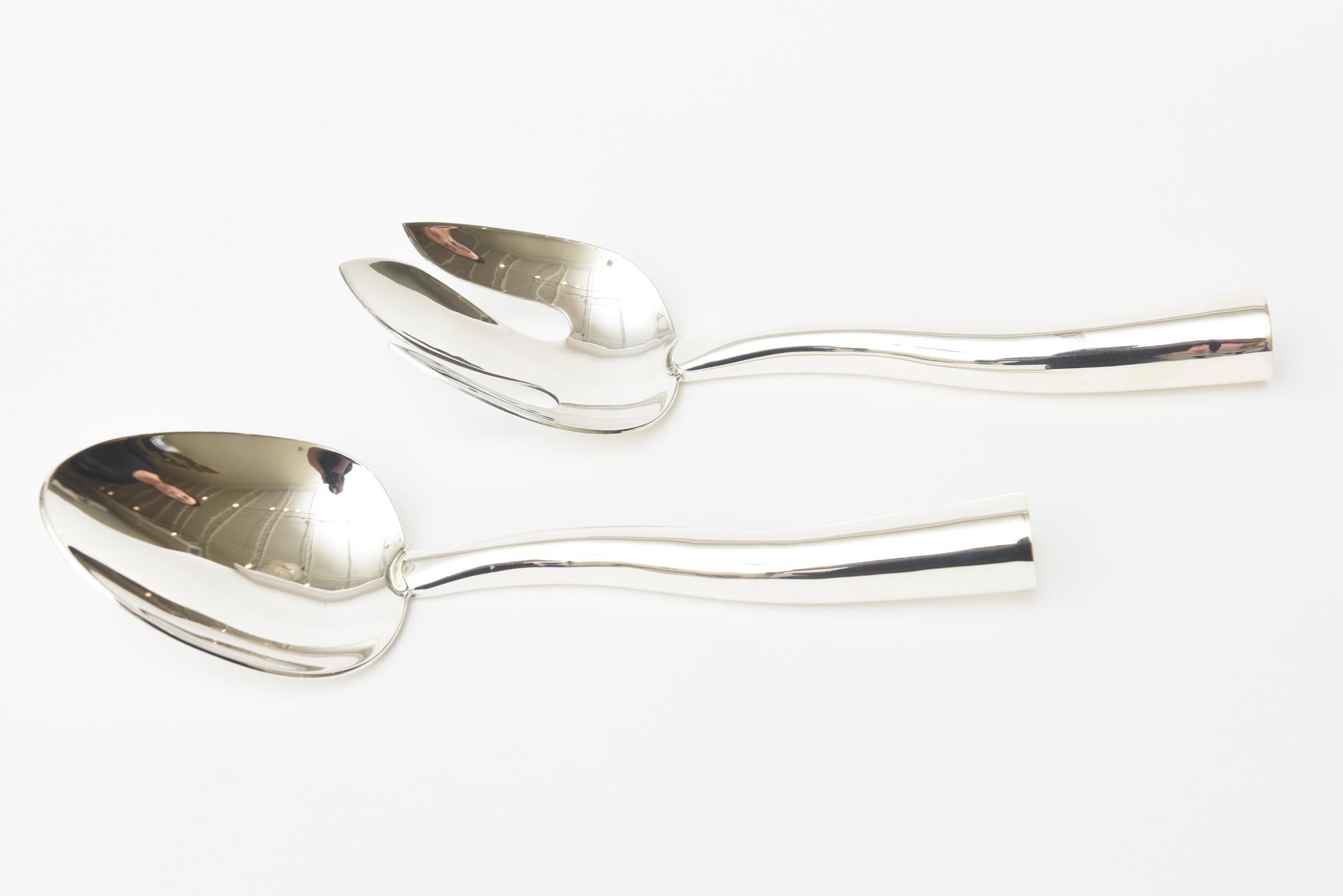 These stunning and sculptural sterling silver modernist vintage sterling silver salad servers and or serving pieces are by Antonio Lopez. They are Mid-Century Modern from the 1960s. They are signed 